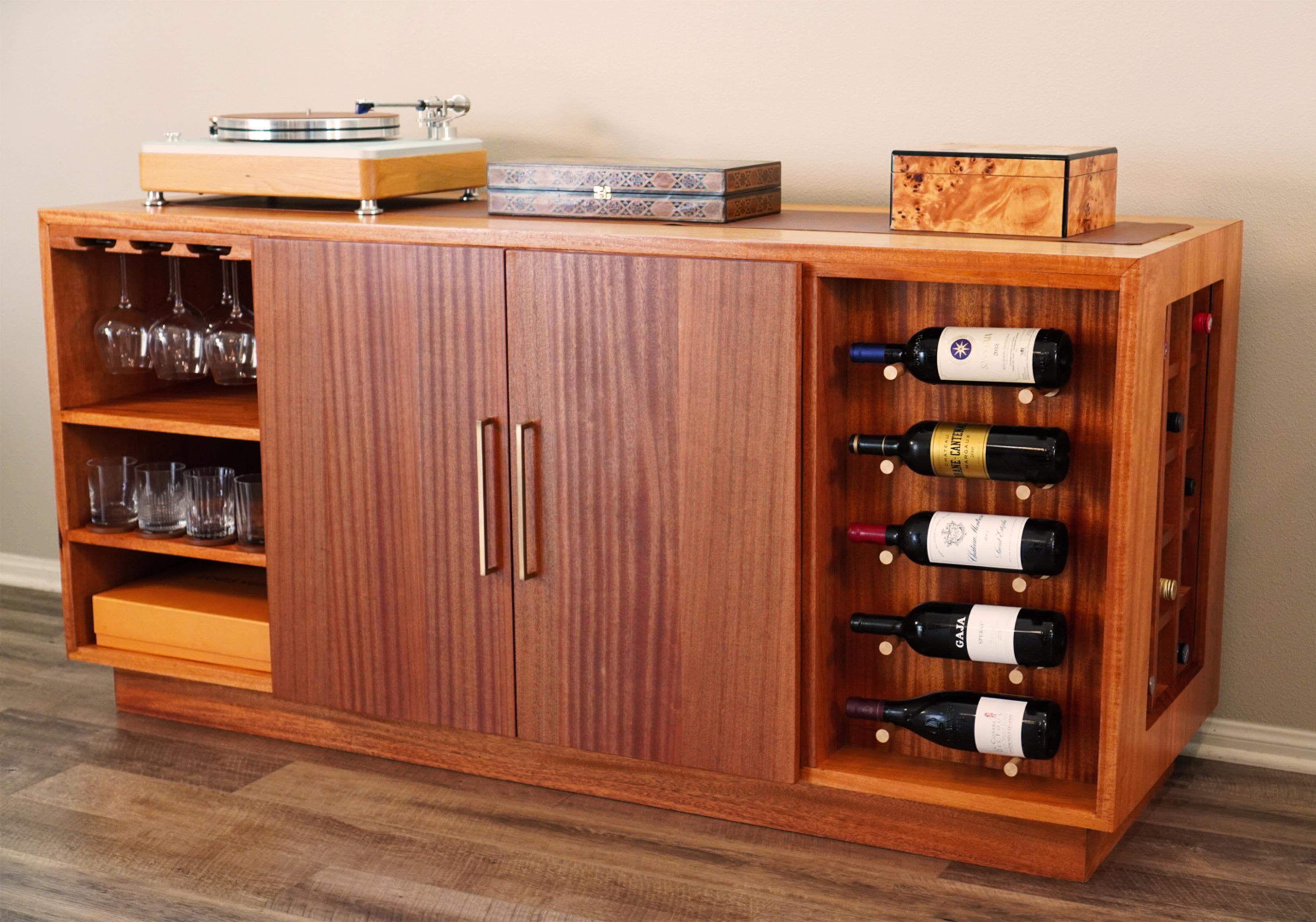 Welcome to Walker Design Studios, where Mid-Century Modern meets timeless craftsmanship. Our Sapele Sideboard Wine and Liquor Cabinet from the Made to Order Collection embodies elegance and functionality, seamlessly blending natural beauty with