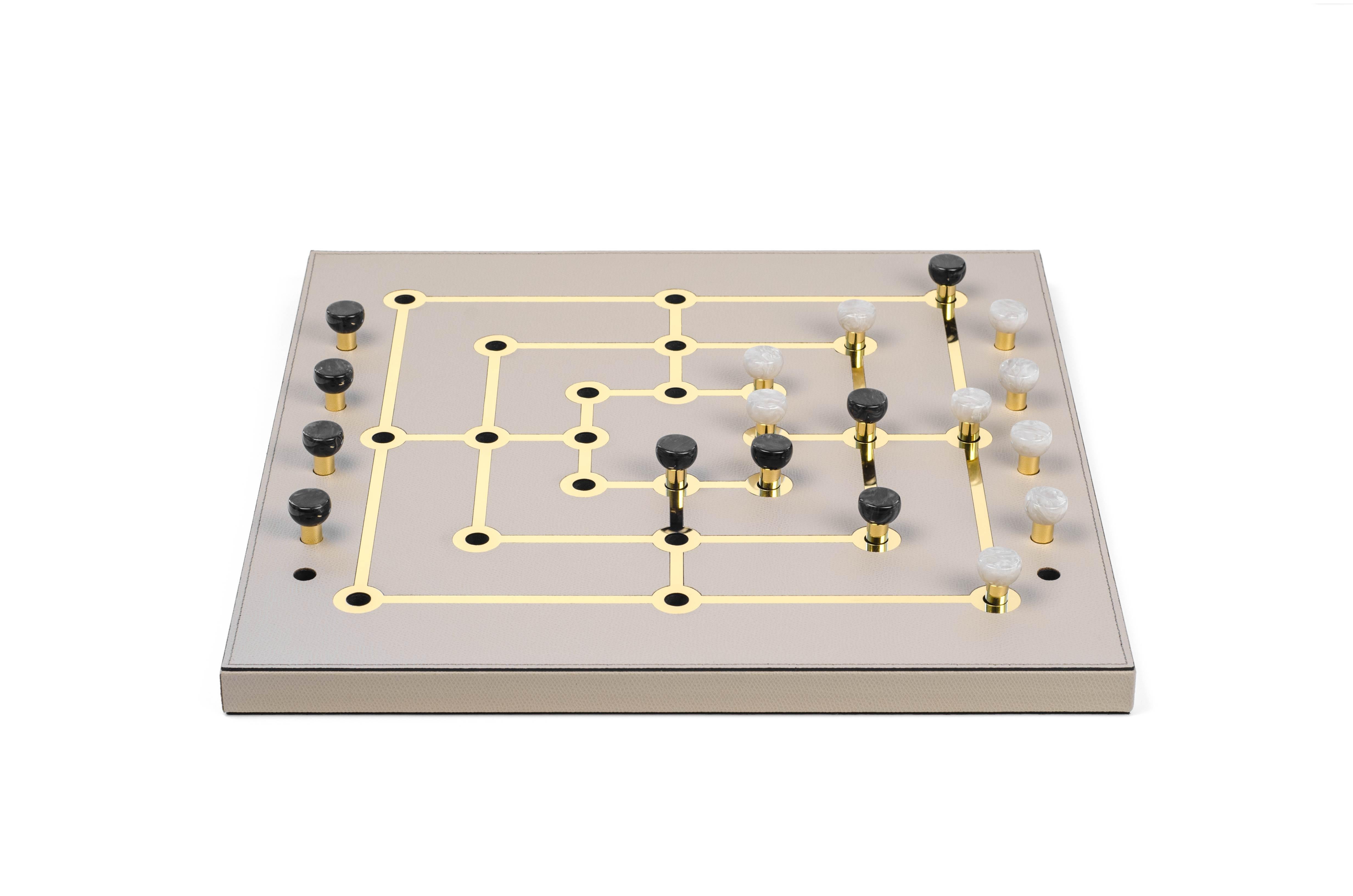 We are glad to welcome aboard our leisure collection the Mill game.

This new brilliant strategy board game is crafted with a luxury field covered in soft calf leather embellished by shiny gold details. The gold brilliance and the eco-shell pawns