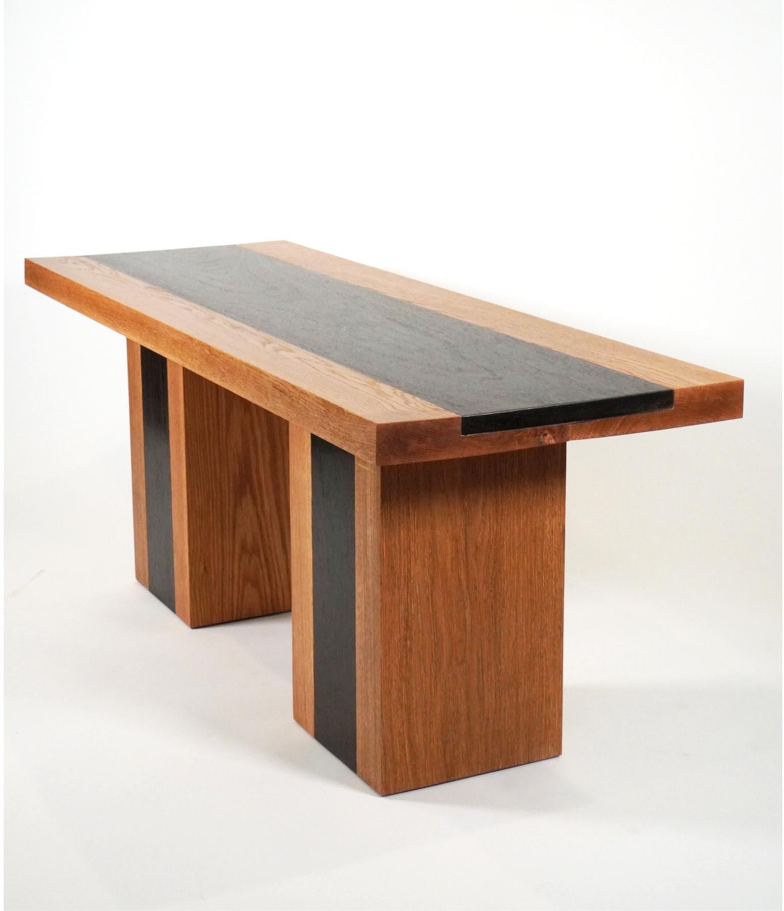 The 21st Century Minimalist Wenge and White Oak Plank Bench is a versatile bench which can function as entry bench, dining bench, or coffee table. The bench is fabricated of rift sawn white oak with Wenge inlays in the top and on the legs of the