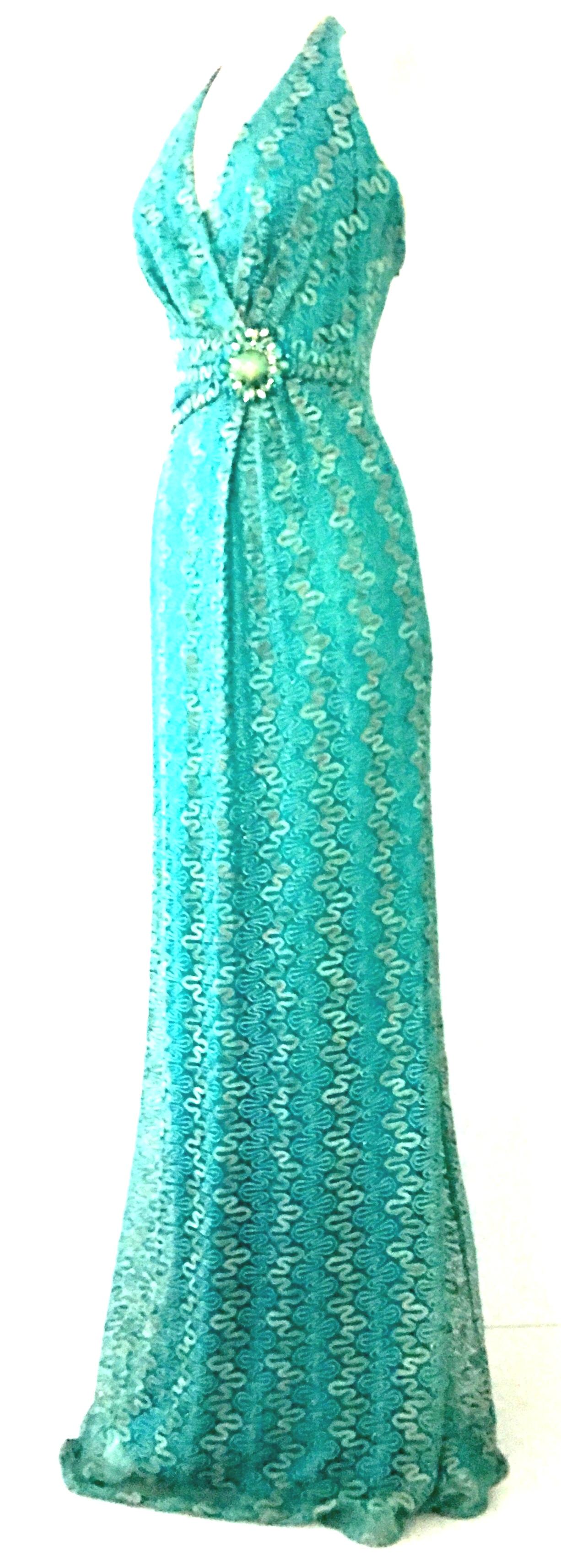 21st Century Contemporary & New With Tags, Missoni Style Maxi Halter Dress By, David Meister. Features a teal knit ground with silver metallic threading detail. The faux belt at the waist features a large 
