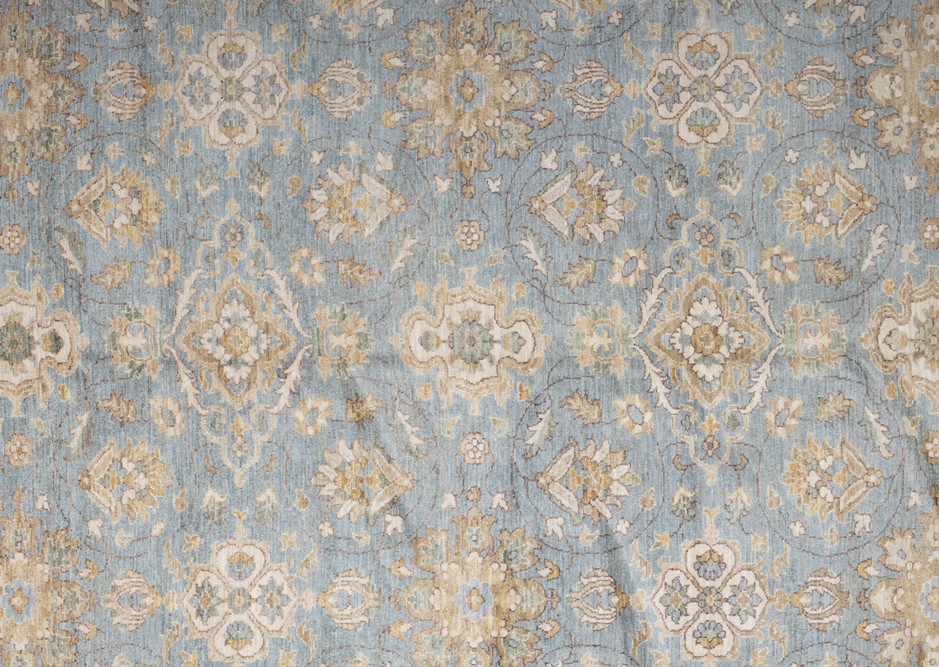 Beautifully detailed modern yet timeless Agra rug from India, featuring a decorative floral and vine pattern throughout. Handwoven by master weavers and made of 100% wool. This sophisticated rug has the perfect balance of light tones making it an
