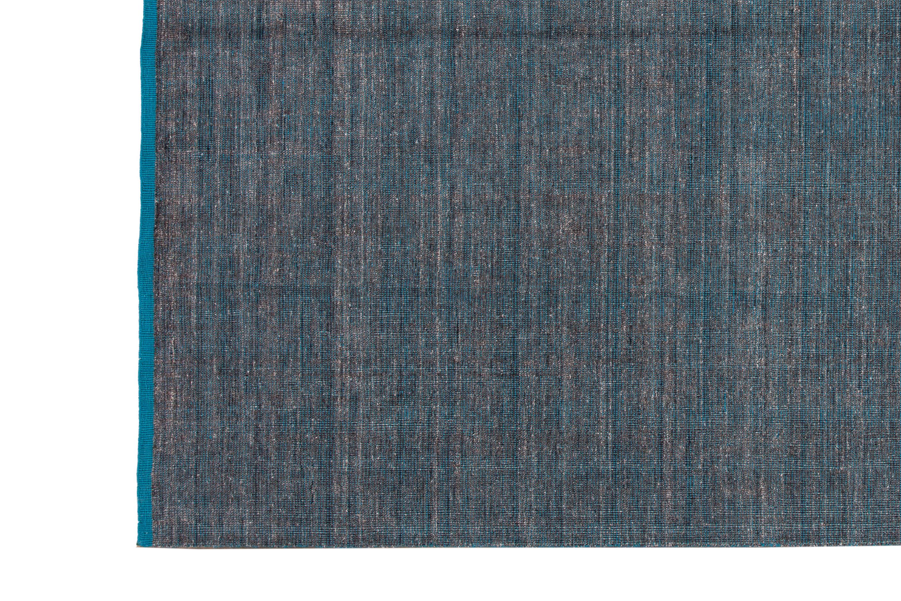 Beautiful modern Handmade Indian bamboo and silk boho rug with a gray and teal field. This Boho Collection Rug has an all-over Solid design.

This rug measures: 9'0