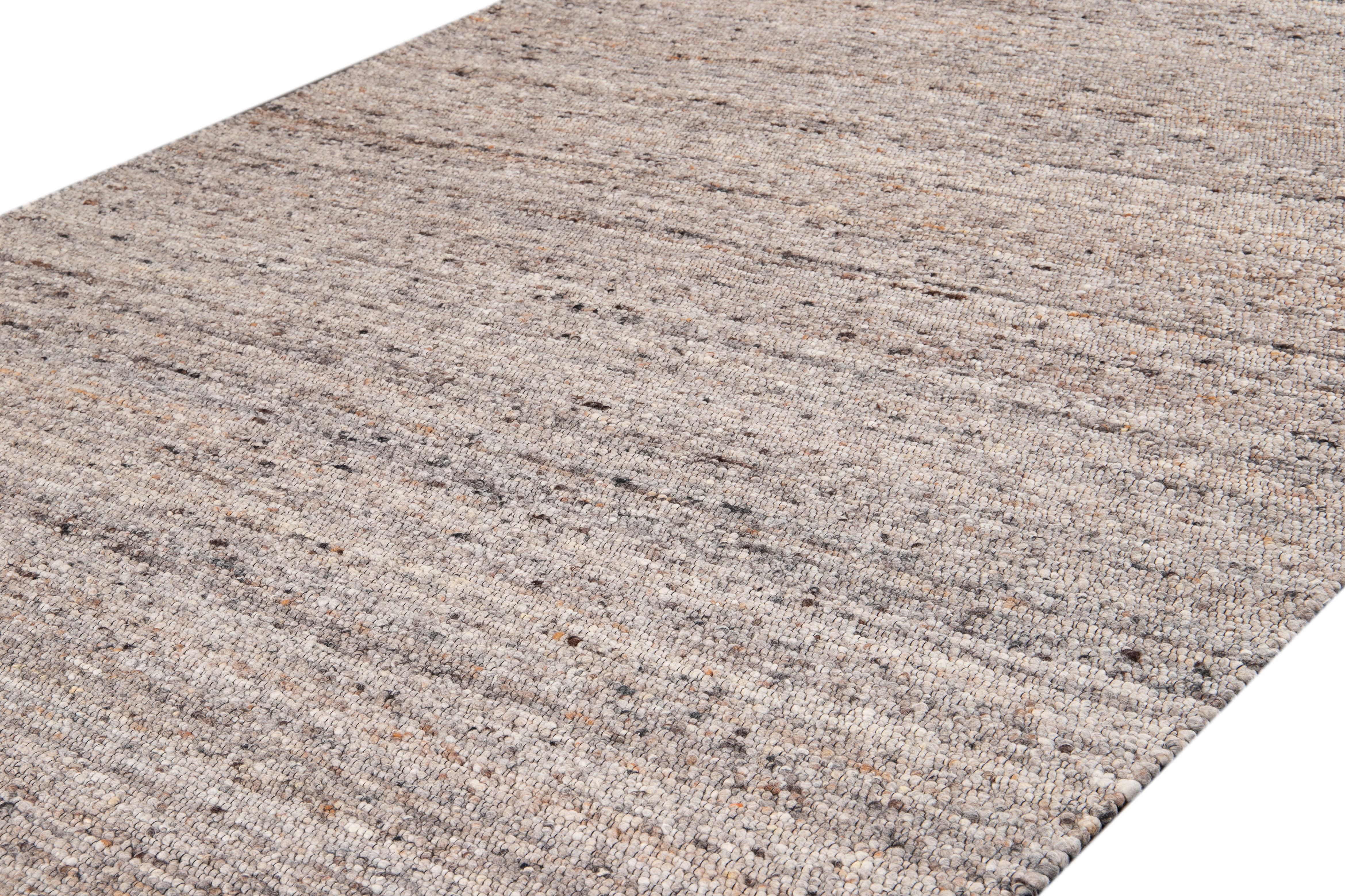 Bellissimo tappeto contemporaneo Texture, in lana annodata a mano con campo marrone, accenti grigio chiaro e arancione, circa 2019.

Questo tappeto misura 9' 0