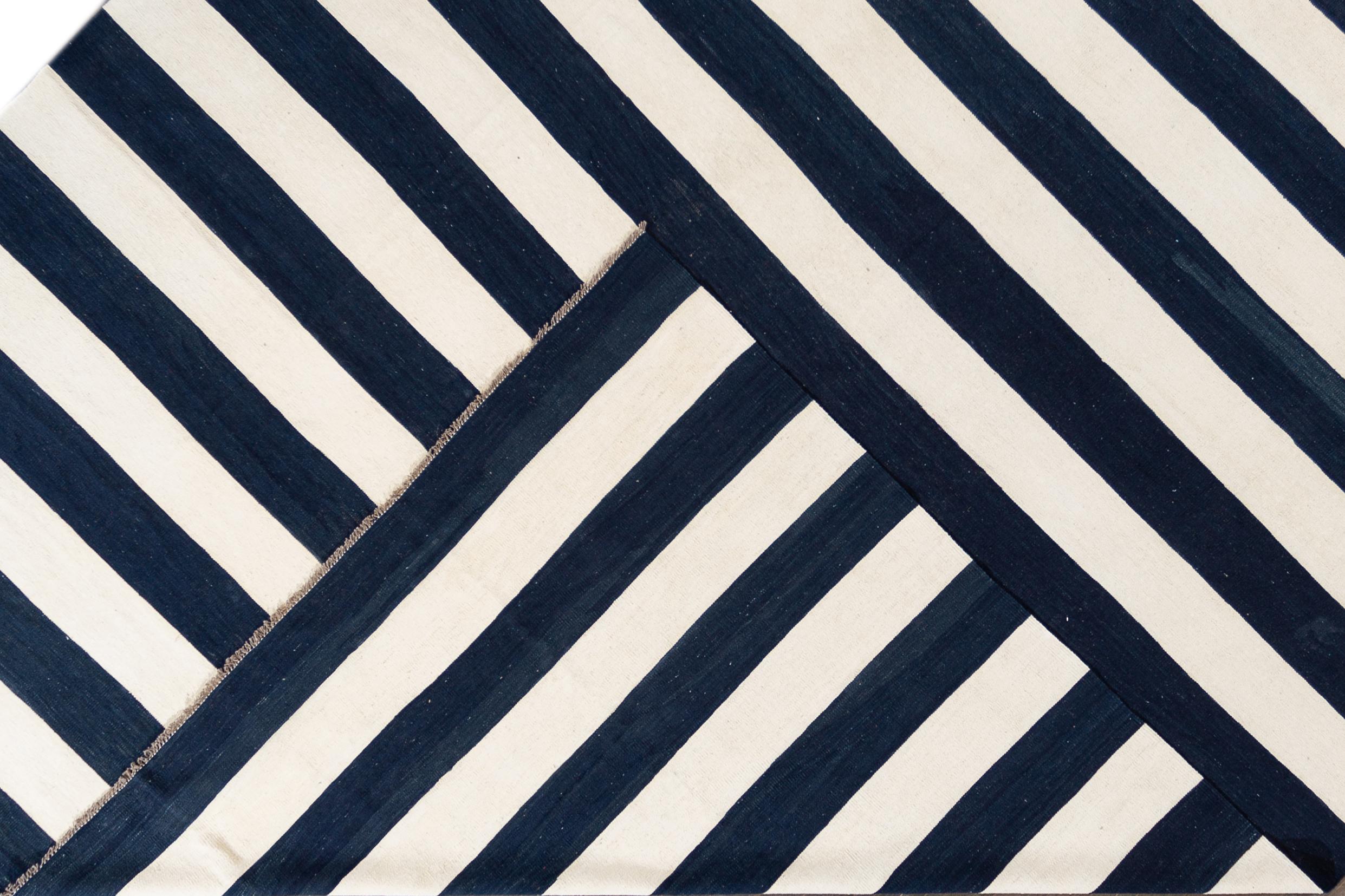 Beautiful 21st century contemporary Kilim Rug, handwoven wool in an all-over blue and white striped design.

 This rug measures 12' 2