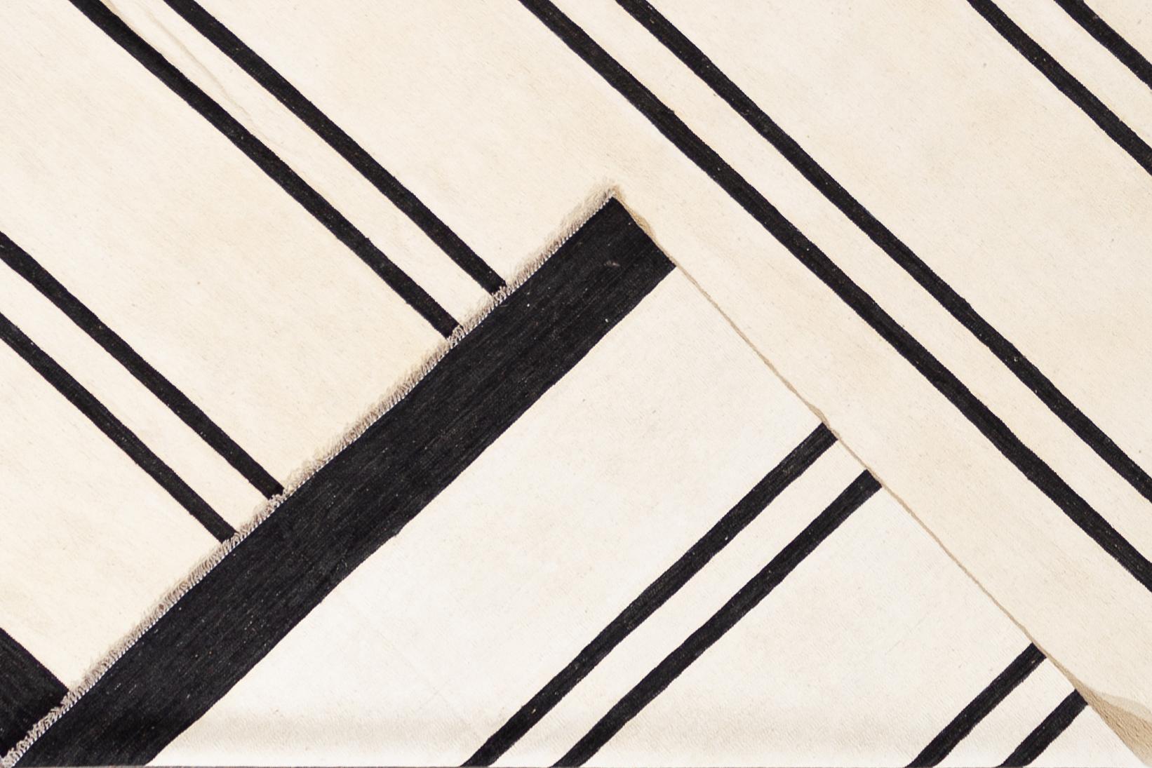 Beautiful 21st century contemporary Kilim rug, handwoven wool in an all-over black and white striped design.

This rug measures 12' 0