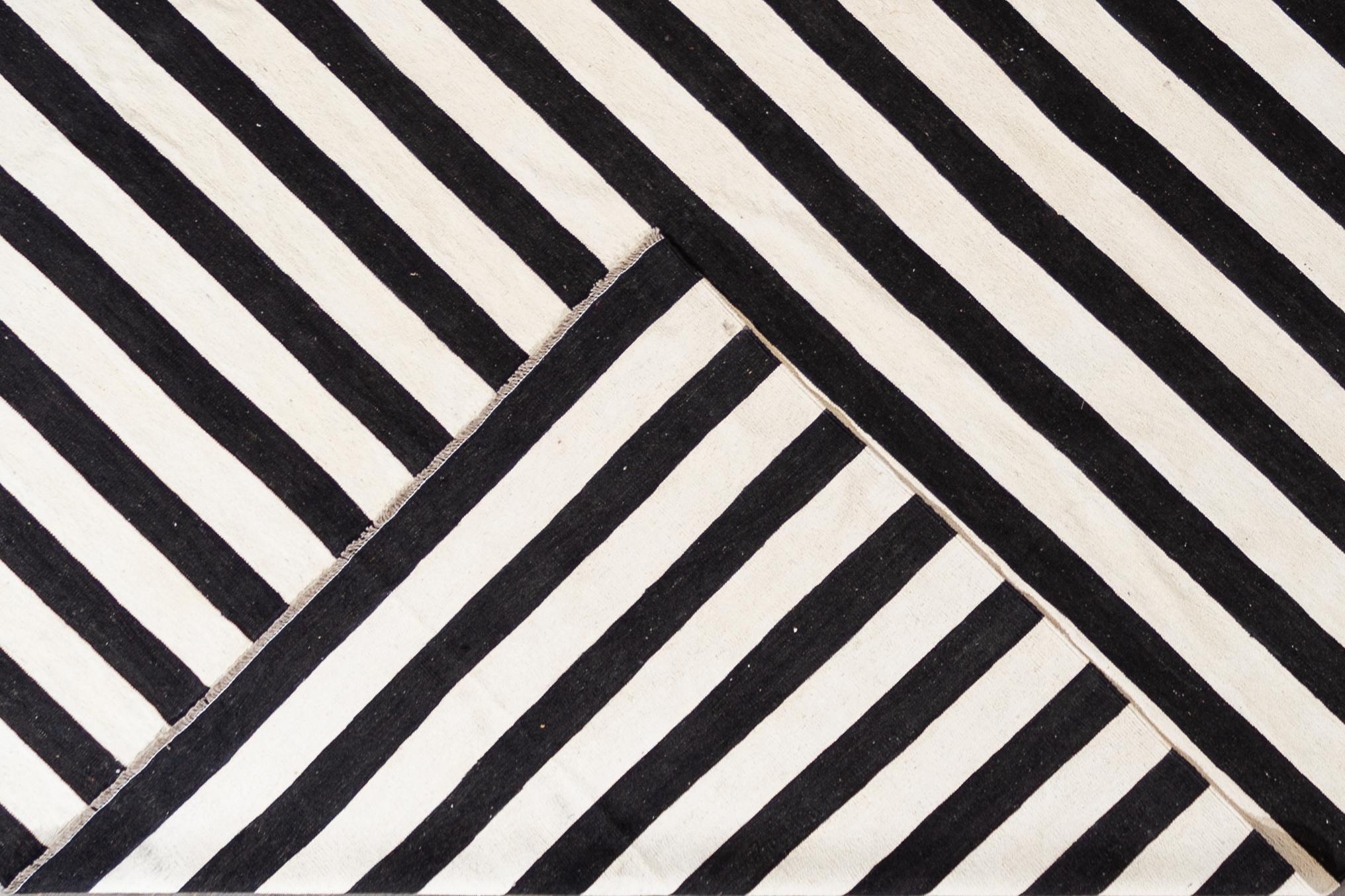 Beautiful 21st Century Contemporary Kilim Rug, hand-woven wool in an allover black and white striped design.

This rug measures 12' 5