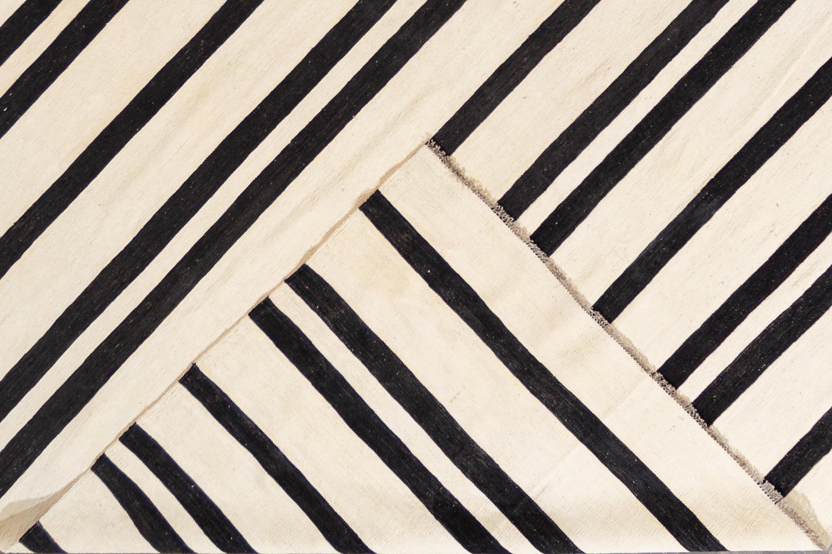 Beautiful 21st century contemporary Kilim Rug, handwoven wool in an all-over black and white striped design.

This rug measures 12' 0