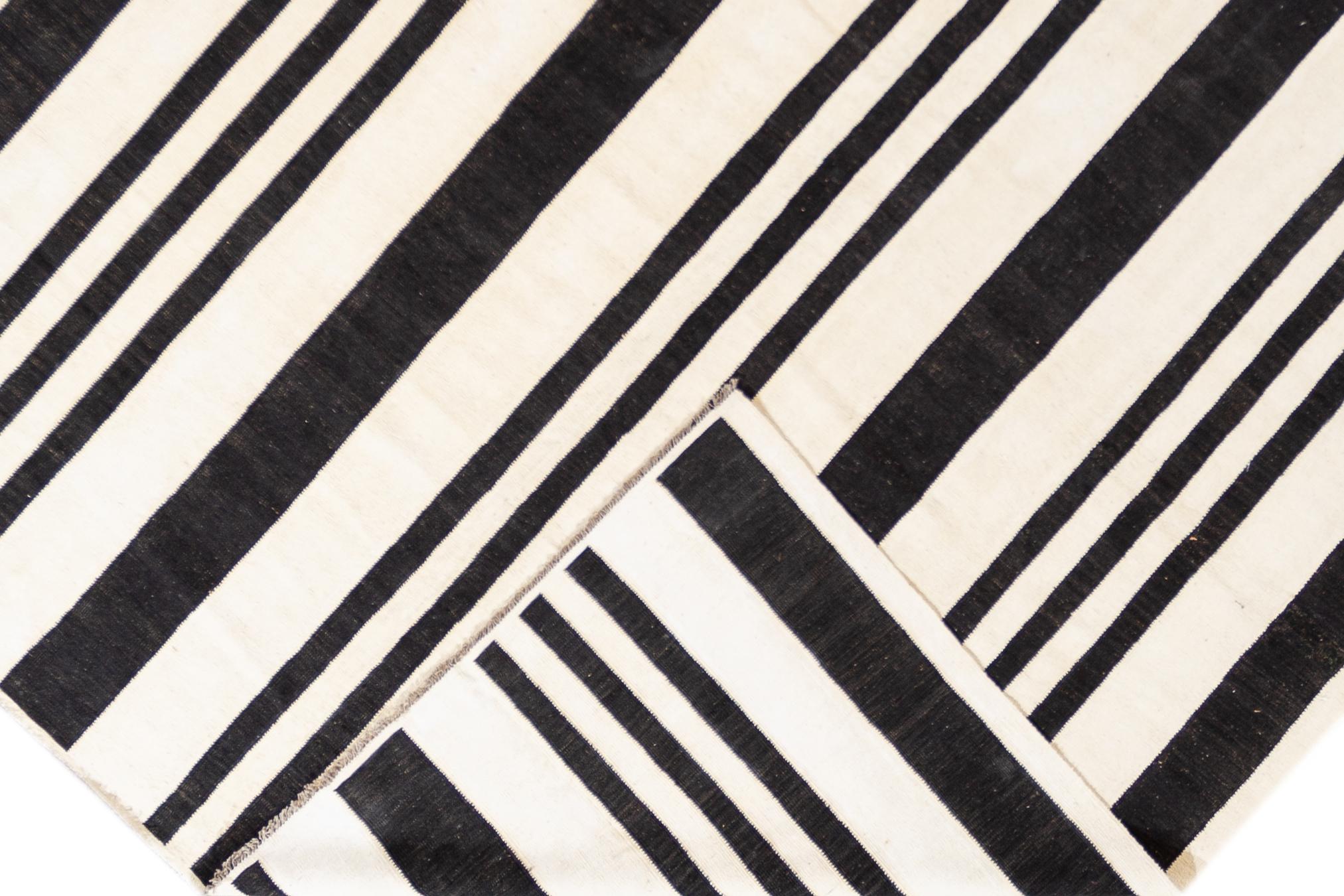 Beautiful 21st century contemporary Kilim rug, handwoven wool in an all-over black and white striped design.

This rug measures 10' 0