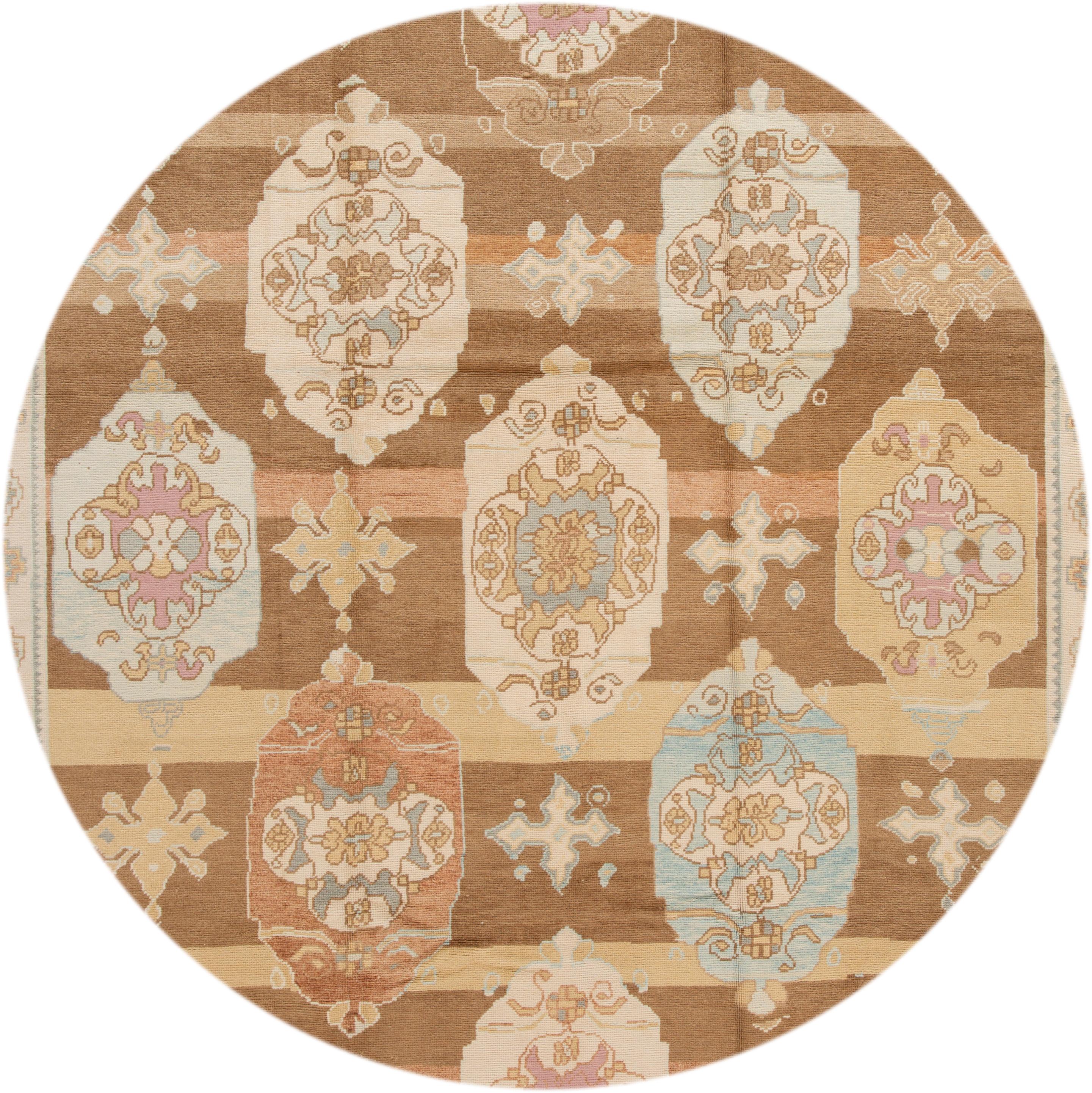 Beautiful contemporary Turkish Kars rug, hand knotted wool with an ivory frame and brown field, multi-color accents in a multi medallion design.
This rug measures: 10'4