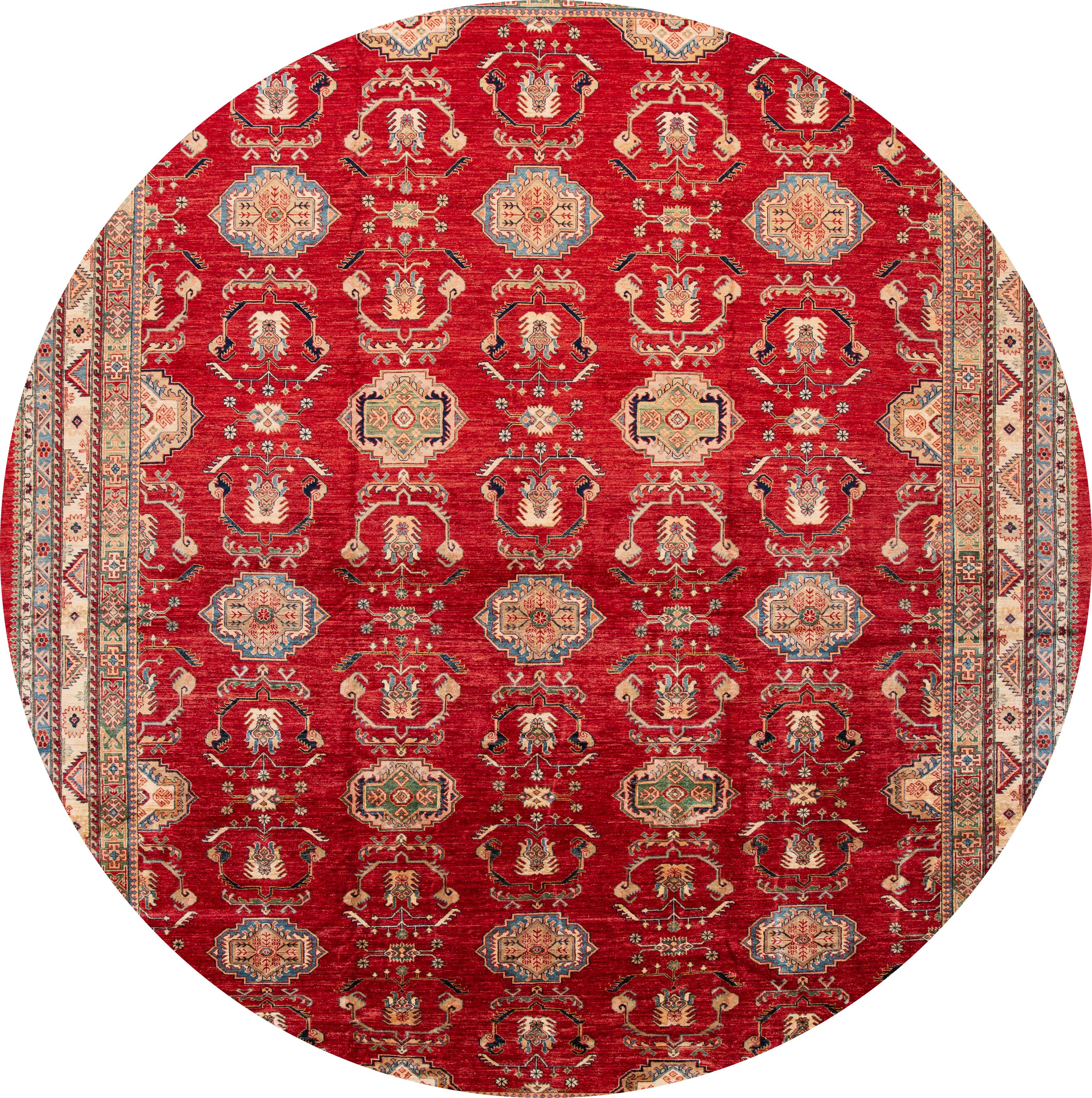 Beautifully contrasted modern Kazak wool rug with a red field, blue and ivory accents in an all-over floral design.

This rug measures: 13'1