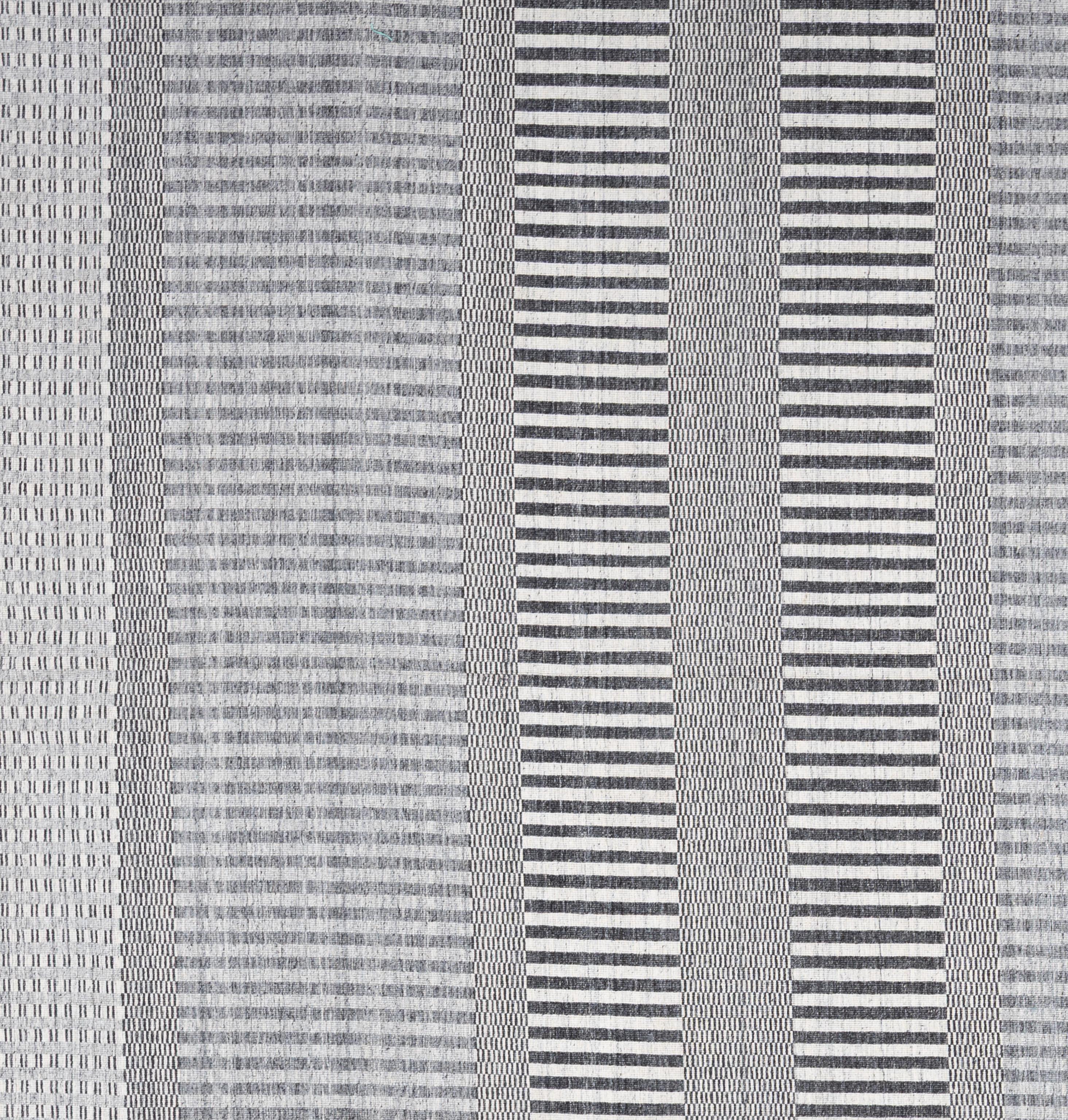 Bold, flatwoven, and effortlessly stylish, this modern kilim rug brings a fresh perspective to a time-honored weaving tradition. Handcrafted using 100% wool, the rug features a low-profile, lightweight construction with the crisp geometry and
