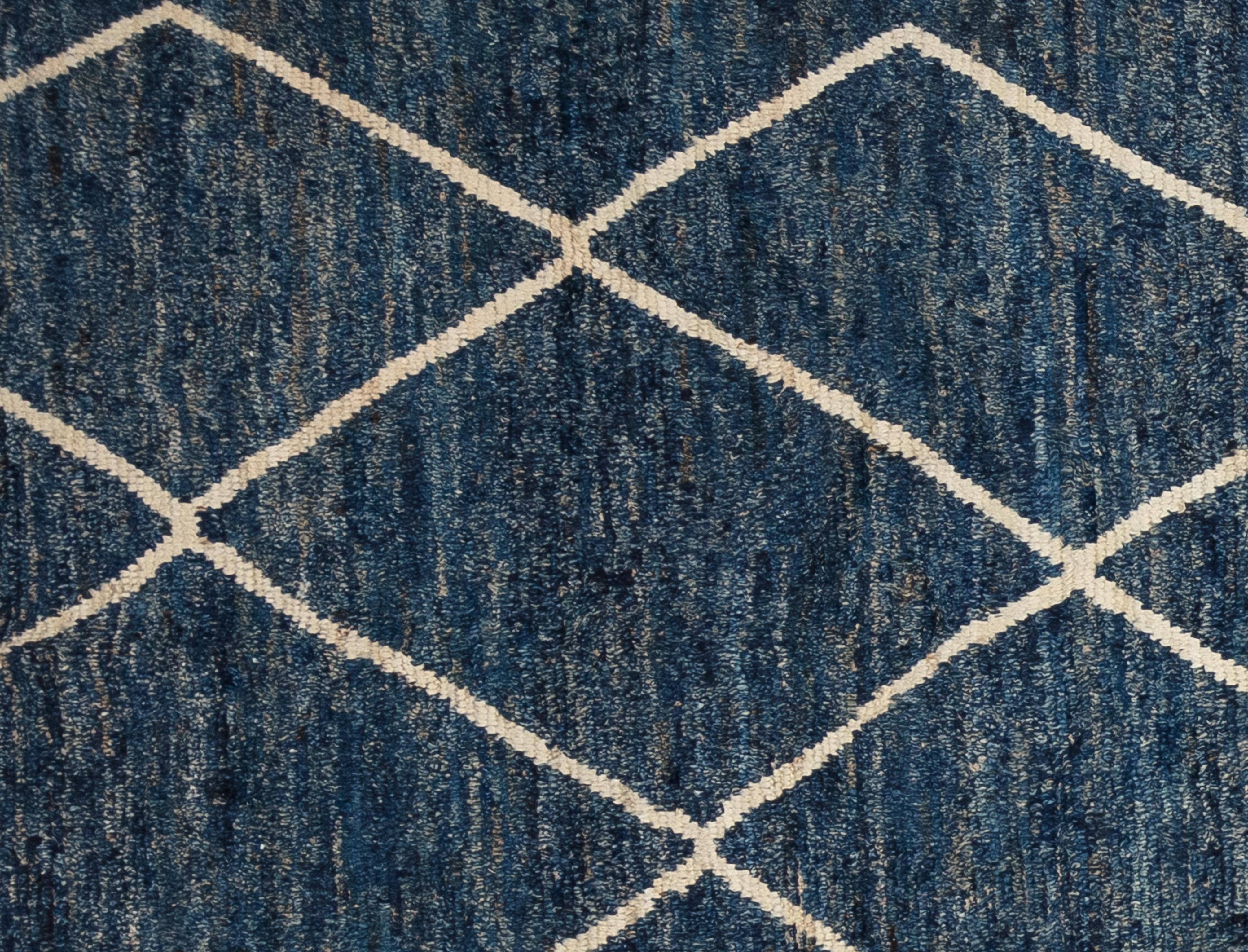 Handwoven with 100% handspun wool, in the subtropical woodlands of Pakistan; this beautiful naturally dyed Moroccan rug is truly one-of-a-kind. Moroccan rugs tend to be simple and are the perfect compliment for your décor. From minimalist modern to