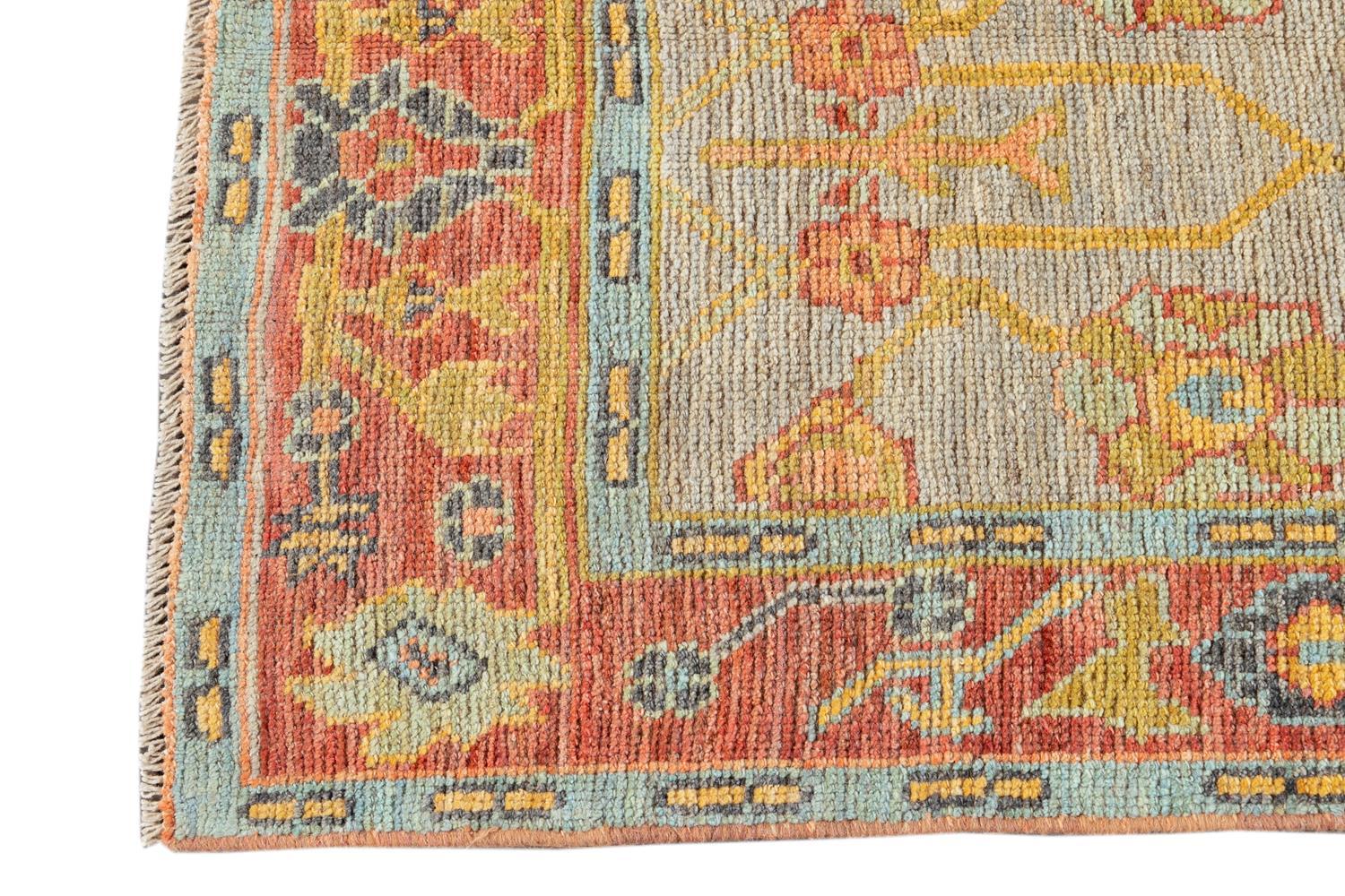 Beautiful hand knotted Modern Oushak rug, with a light gray field, rust, golden and blue accents in an all-over geometric floral design.

This rug measures 2' 7