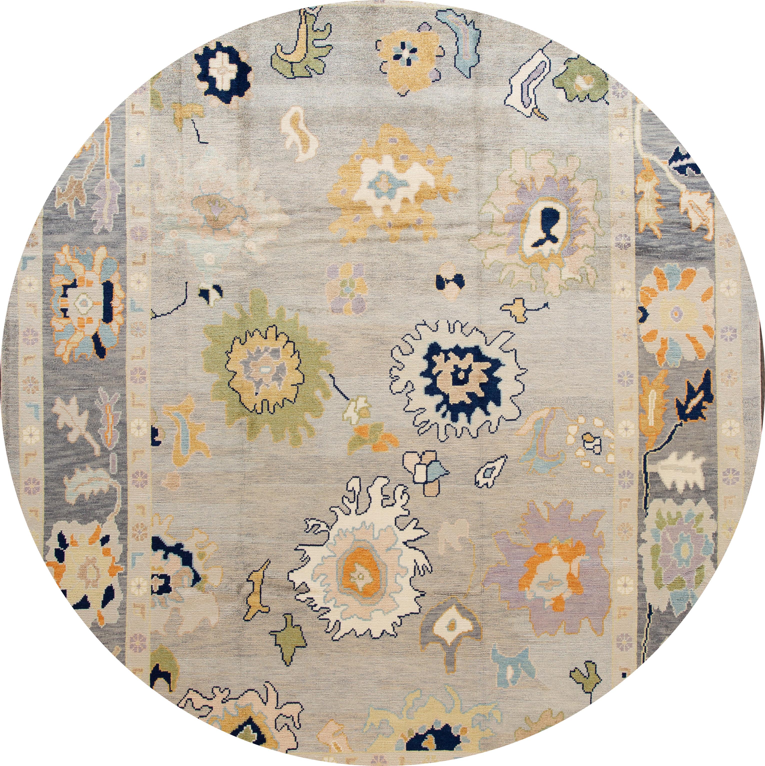 Beautiful contemporary Turkish Oushak rug, hand knotted wool with an ivory frame and gray field, multi-color accents in a multi medallion design.
This rug measures: 10' x 14'.