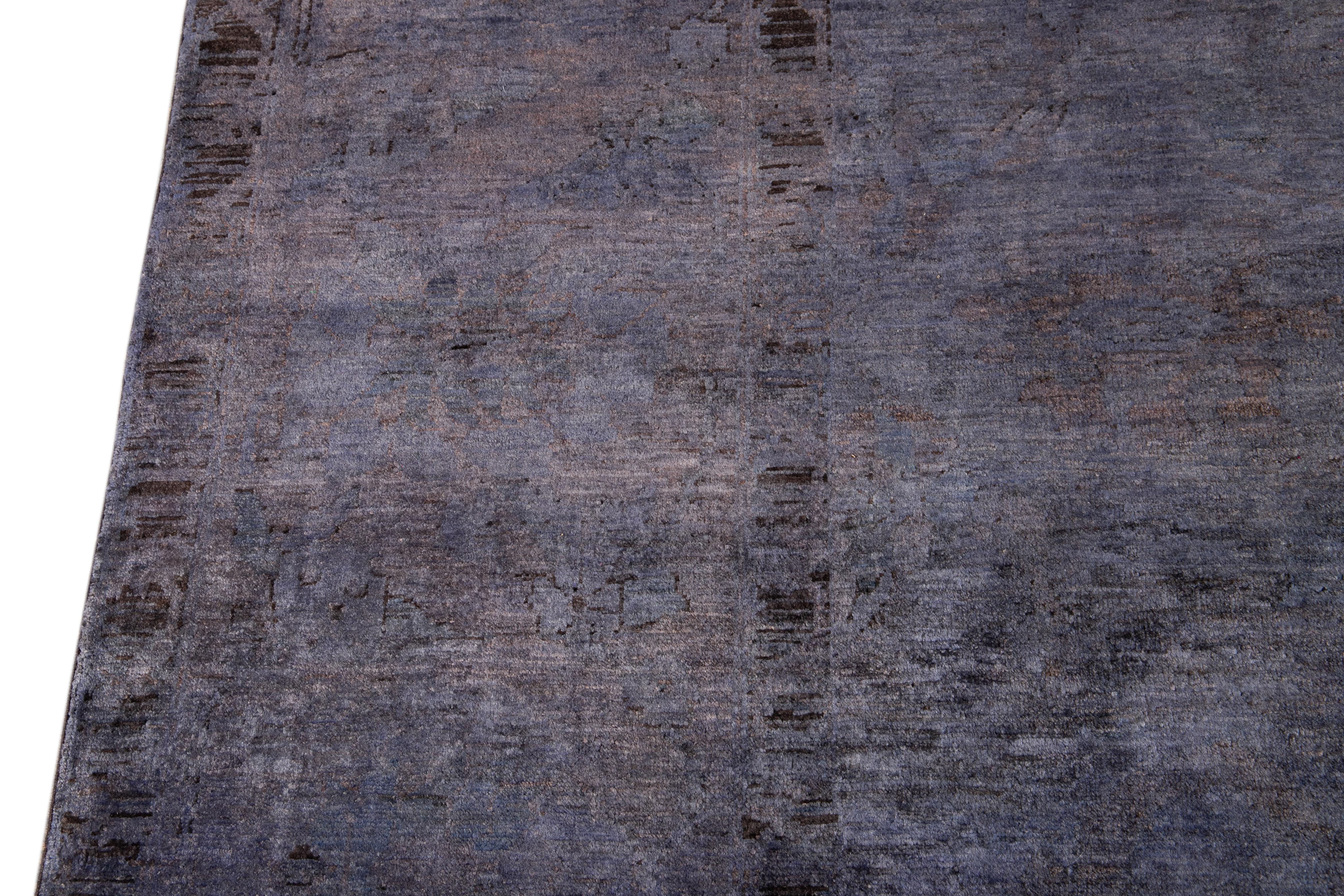 Dieser exquisite, moderne, gefärbte Teppich besteht aus handgeknüpfter Wolle mit einem üppigen violetten Feld und zarten schwarzen Akzenten, die in einem zeitlosen klassischen Motiv angeordnet sind. Dieses etwa 2019 entstandene Stück ist ein