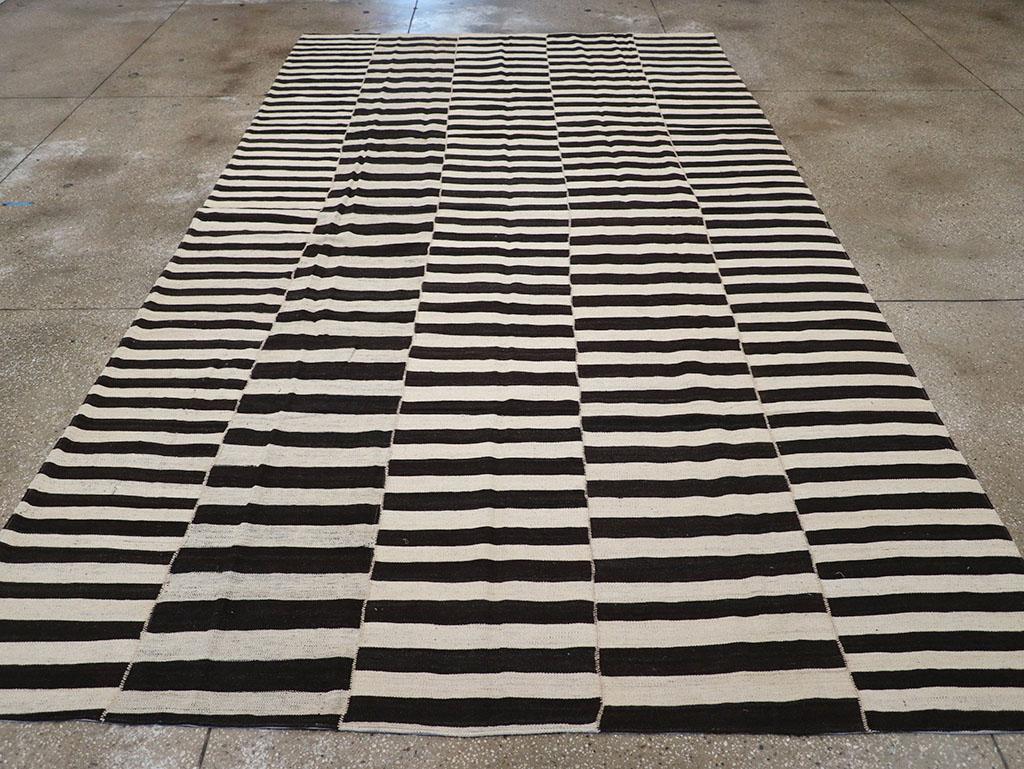This 21st century Persian Flatweave Kilim rug, measuring 7' 7