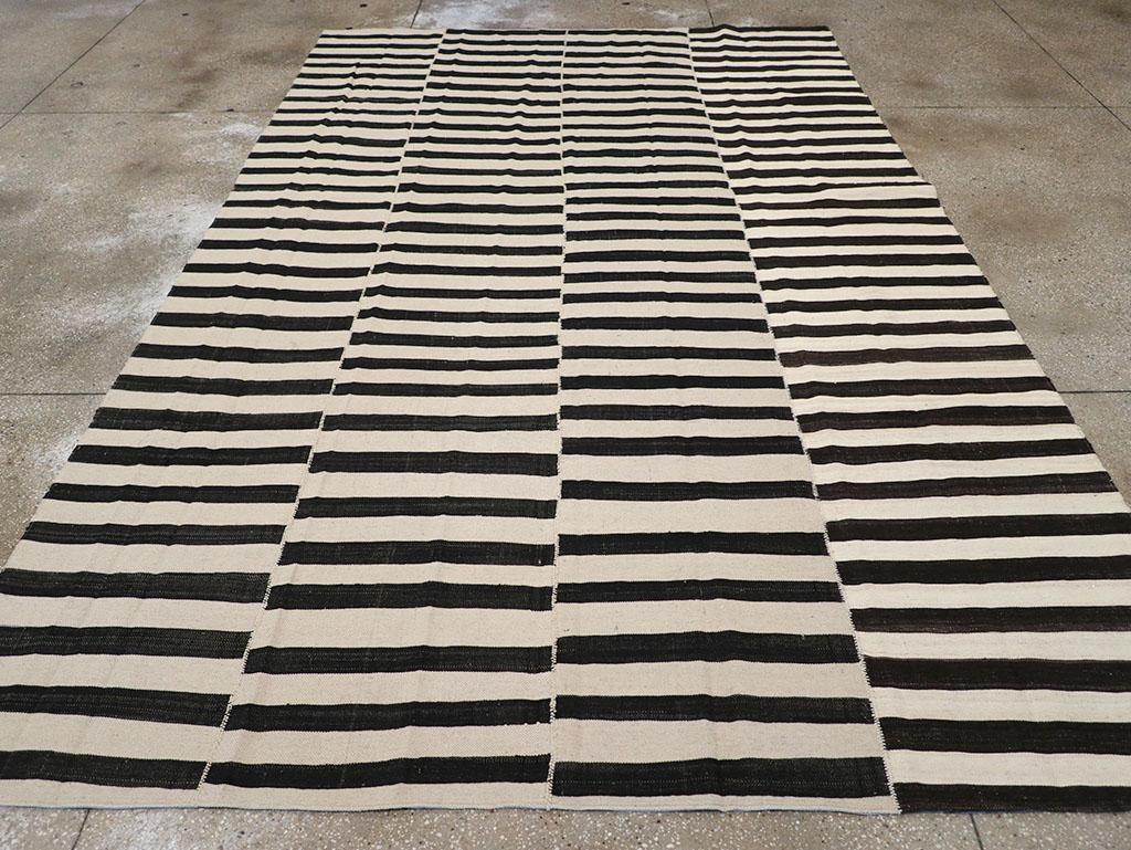 This 21st century Persian Flatweave Kilim rug, measuring 7' 9