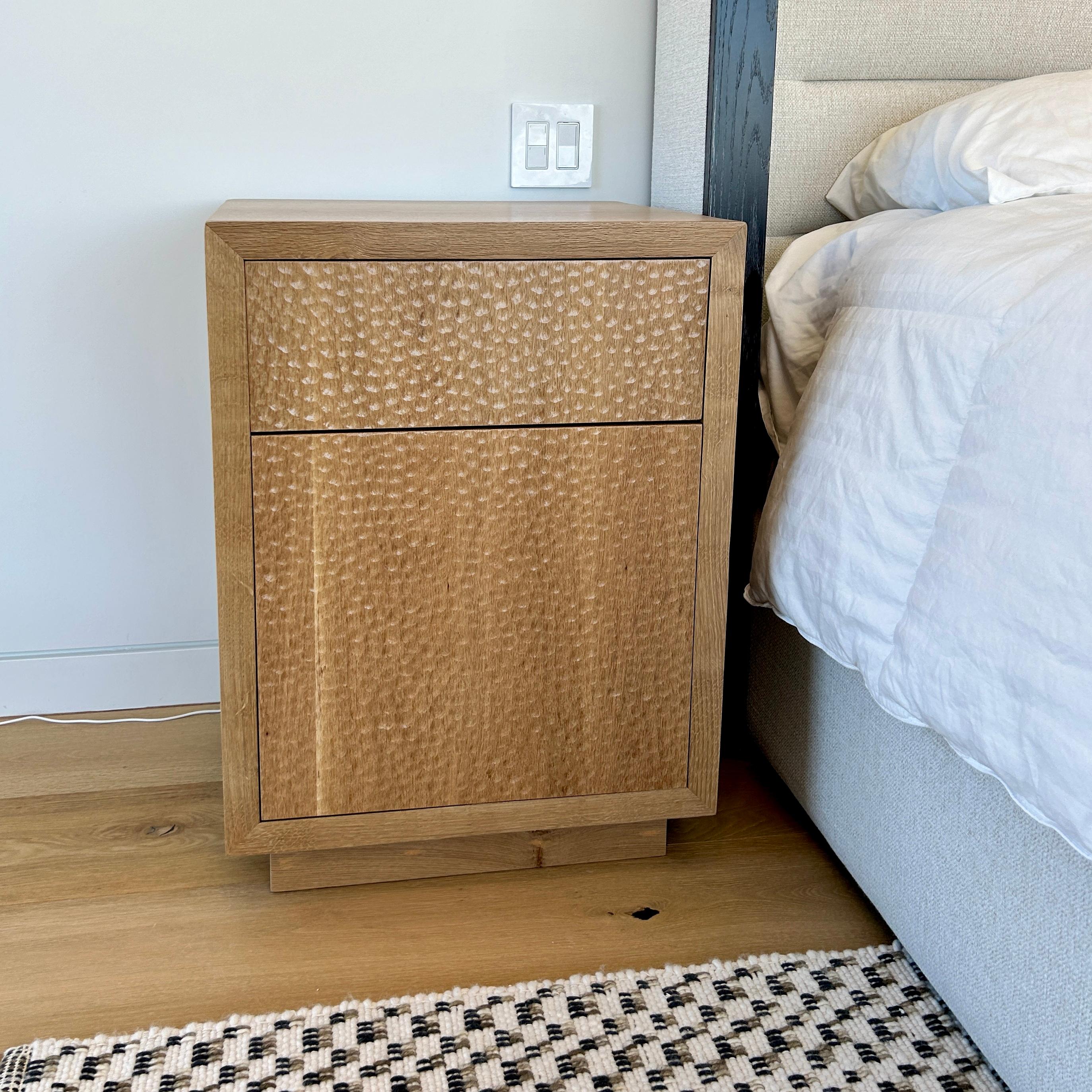 Introducing the Rift Sawn White Oak CPAP Nightstand, a premium addition to your bedroom ensemble. Crafted with meticulous attention to detail, this nightstand boasts an exterior of exquisite rift sawn white oak, adorned with captivating hand-gouged