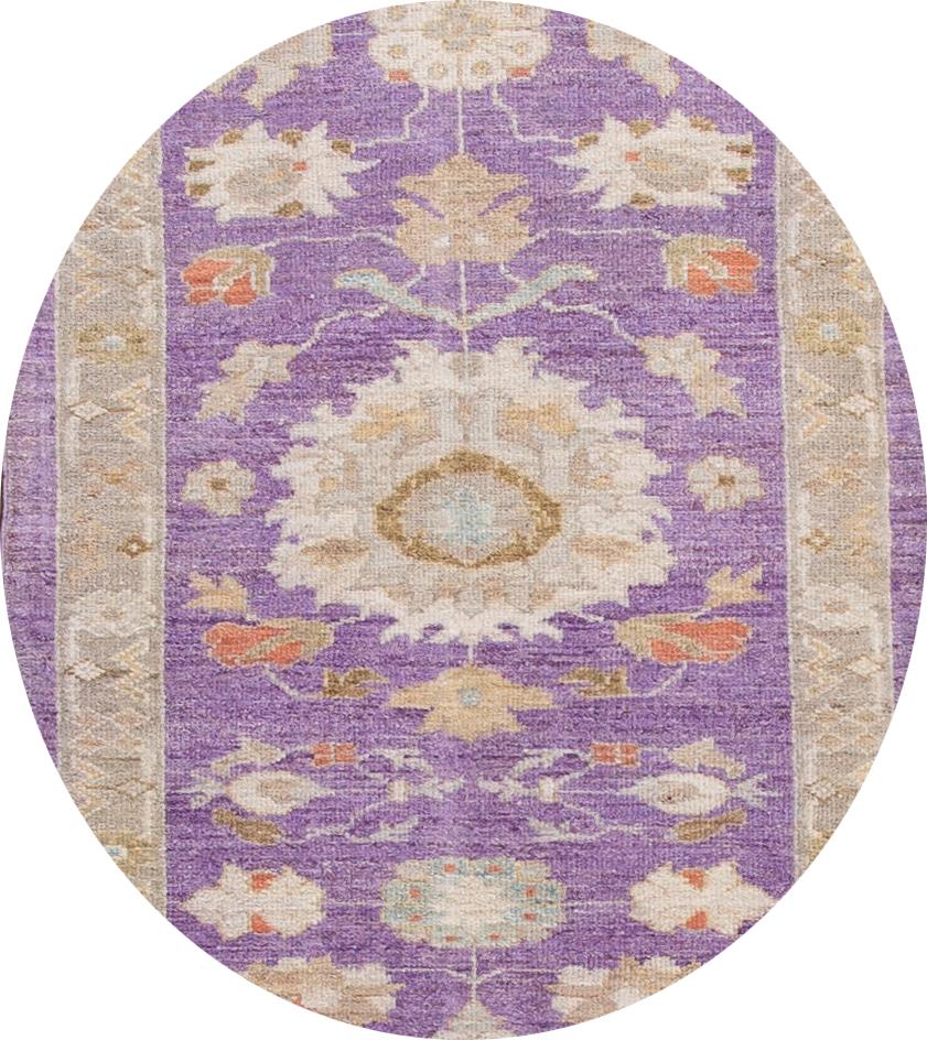 Beautiful contemporary Sultanabad runner rug, hand knotted wool with a purple field, slim tan frame, tan, ivory, and rust accents in an all-over design.
This rug measures 3' 5