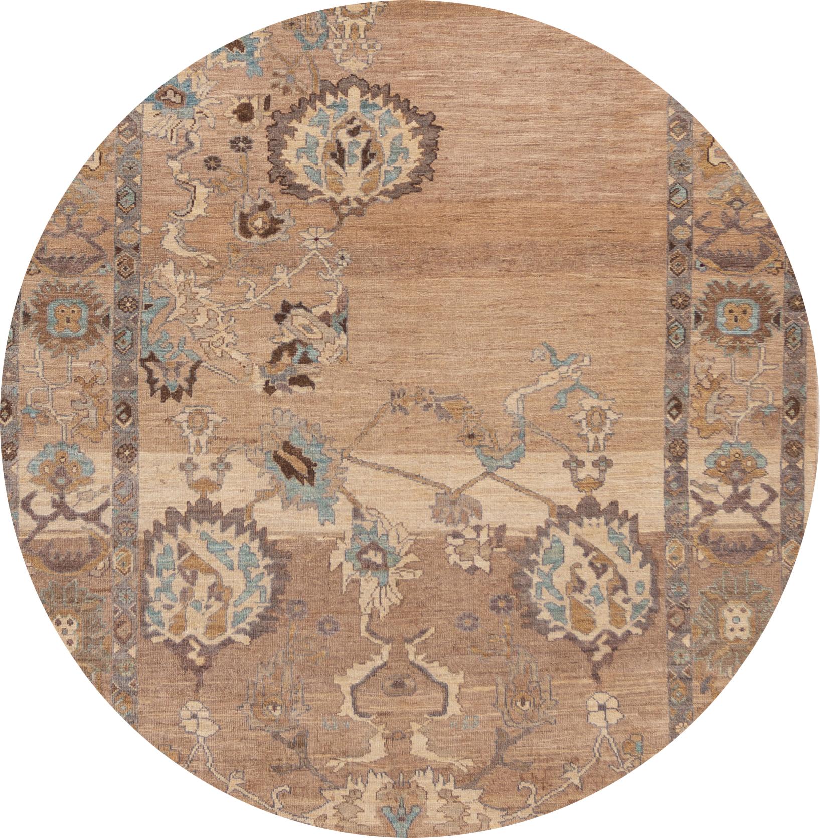 A hand knotted Sultanabad rug with a floral design and border on a brown field. Accents of beige, blue and dark brown throughout. 

This rug measures 6'9