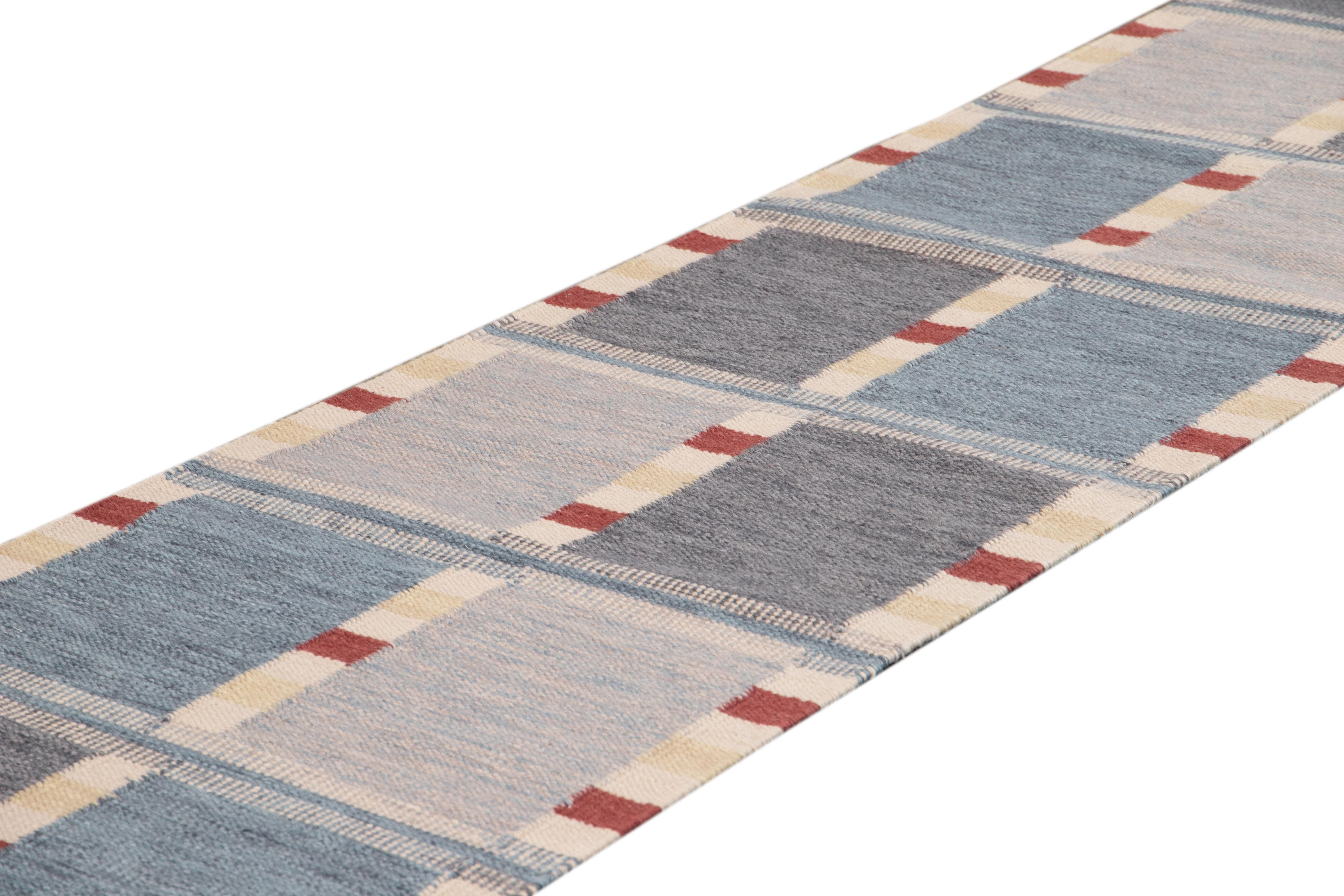 Beautiful contemporary Swedish style runner rug, hand knotted wool with a blue field, ivory and red accents in an all-over Classic Scandinavian geometric design.
This rug measures 3' 4
