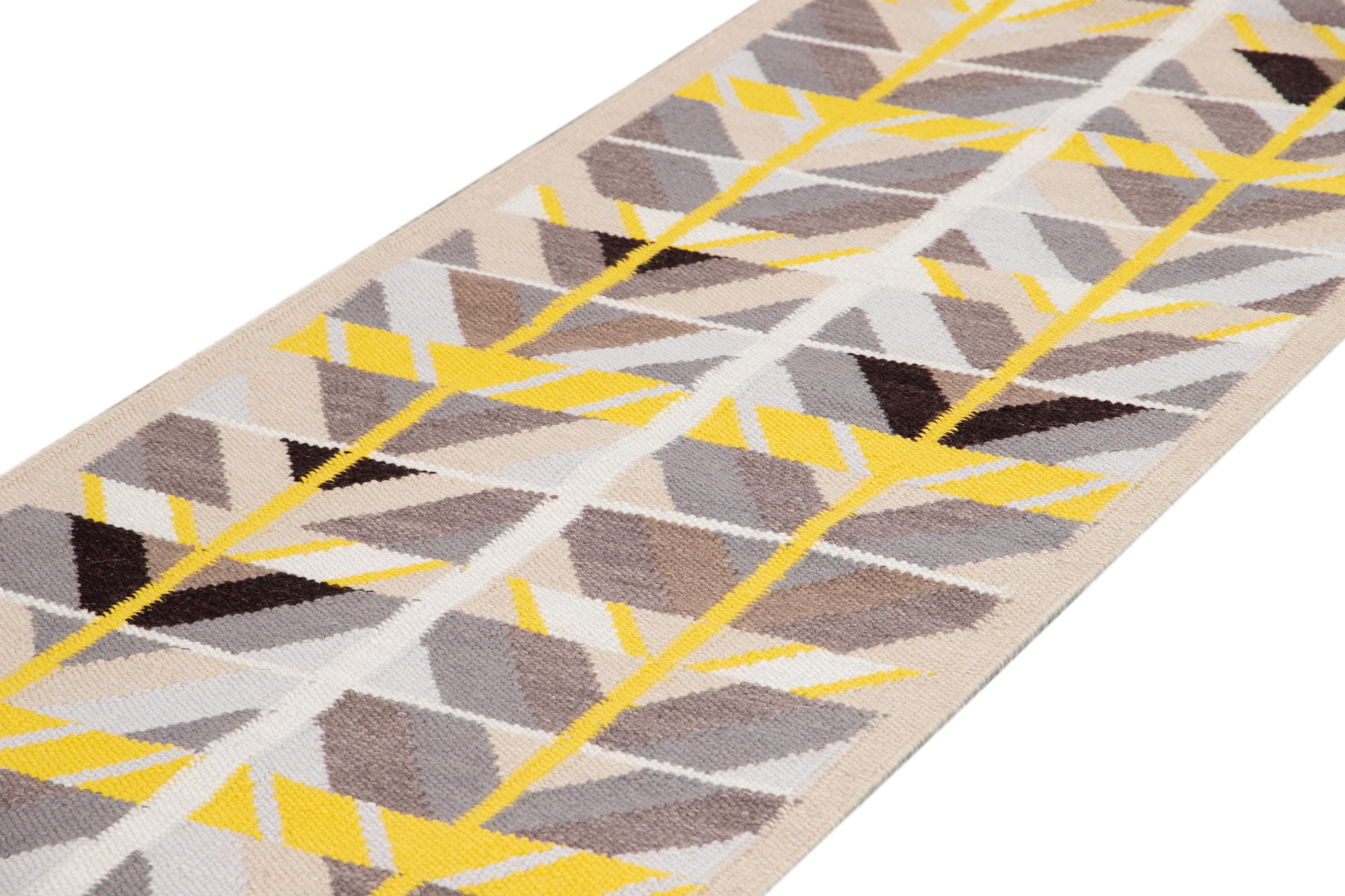 Beautiful contemporary Swedish style runner rug, hand knotted wool with a cream tan field, bright yellow and gray accents in an all-over Classic Scandinavian geometric design.
This rug measures 3' x 18' 3