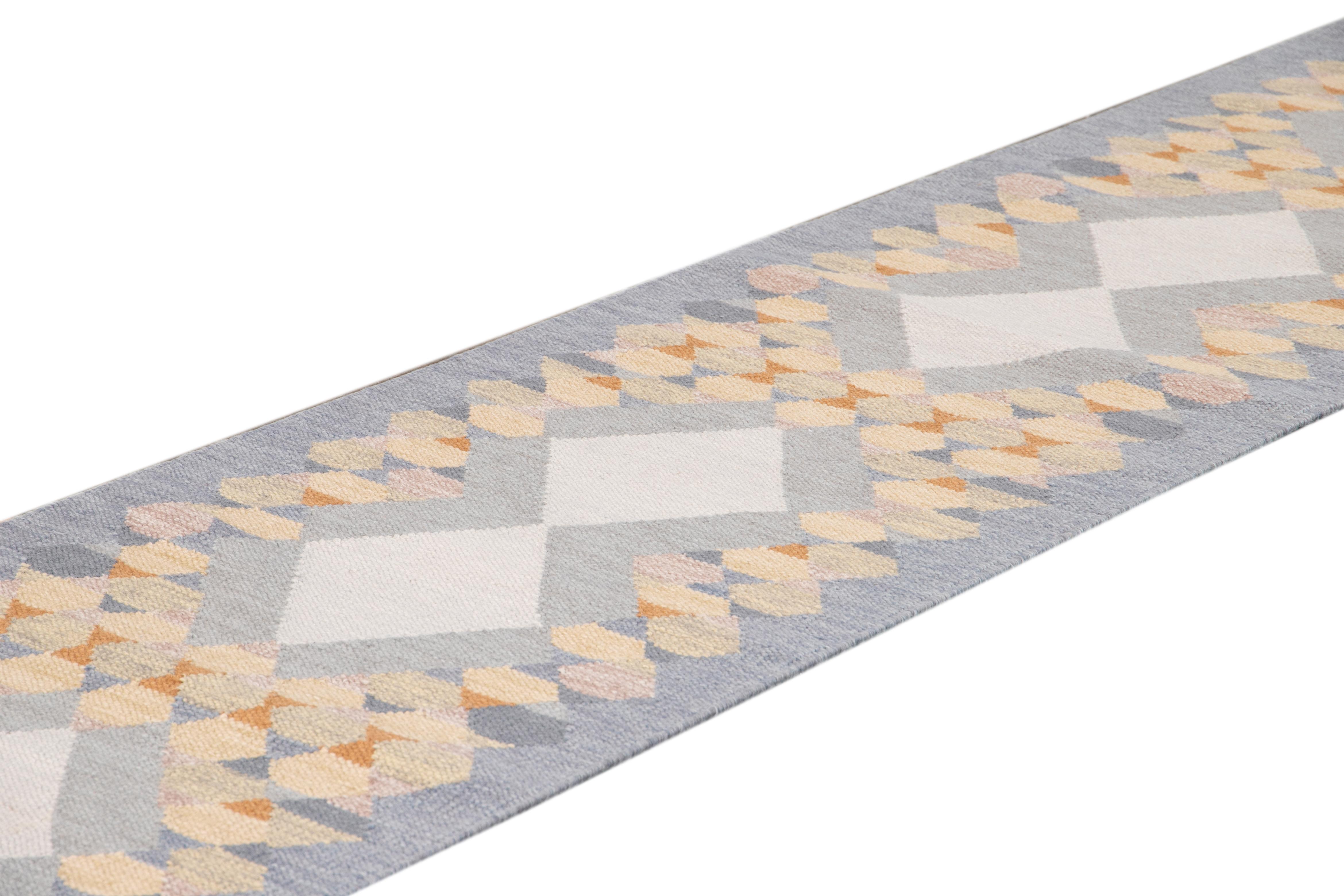 Beautiful contemporary Swedish style runner rug, hand knotted wool with a light blue field, tan and multicolor accents in an all-over Classic Scandinavian geometric design.
This rug measures 3' x 18'.
 