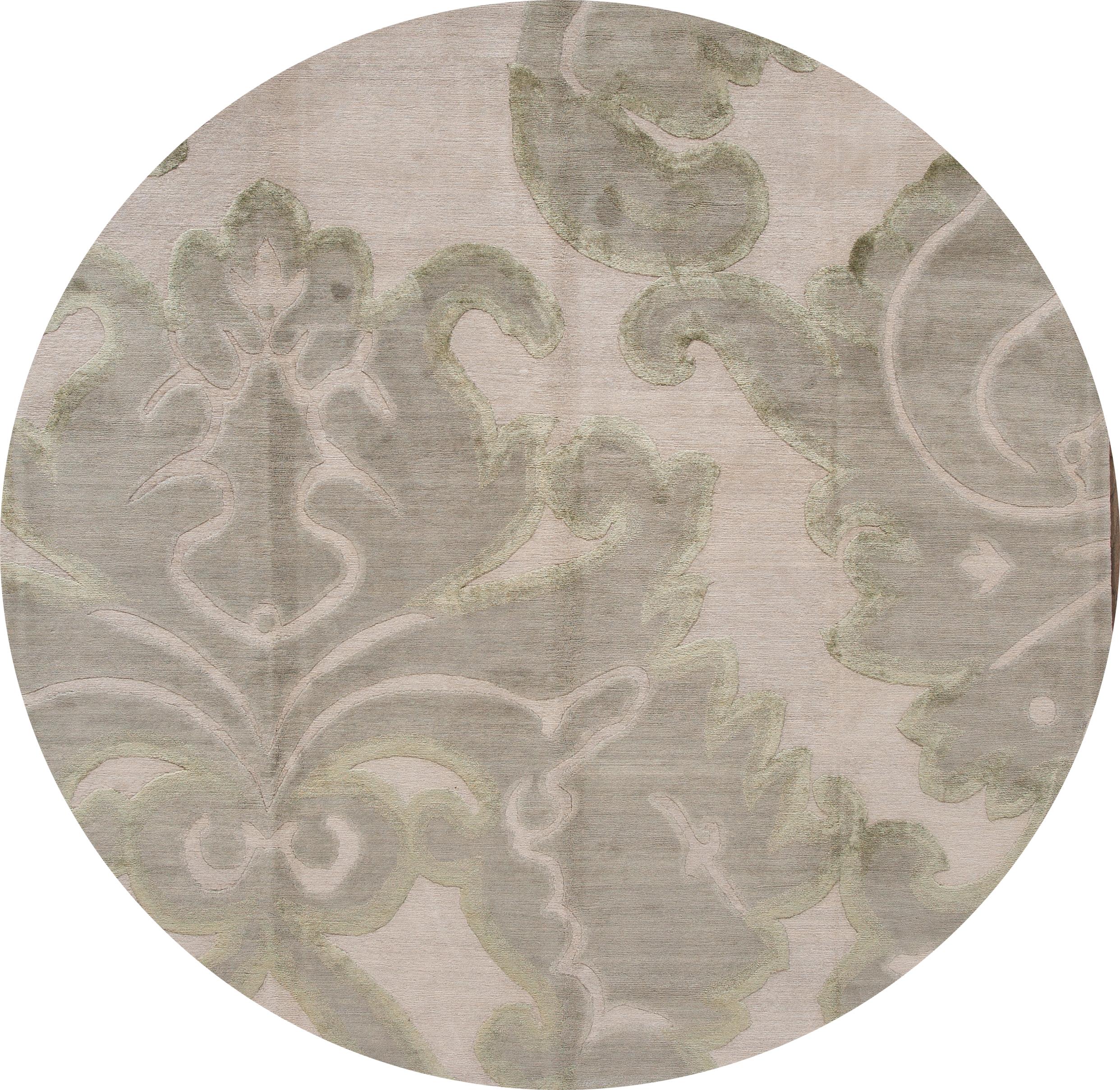 A hand knotted modern Tibetan rug with the gray field. Accents of cream an artistic design. 

This rug measures 8' x 10'.