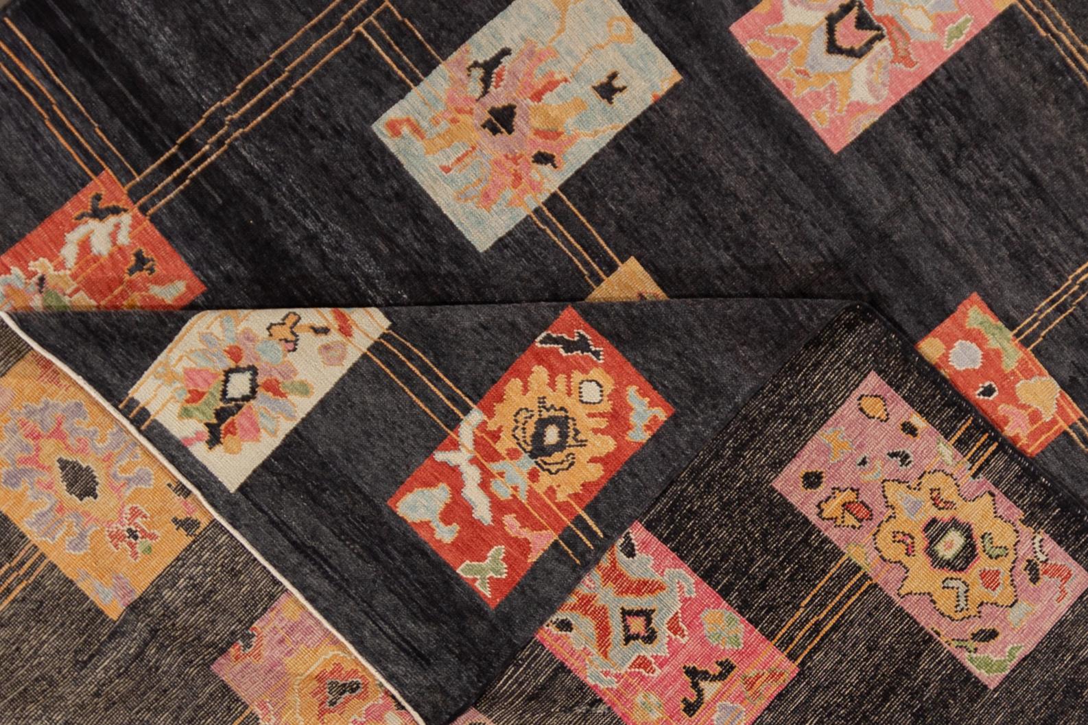 A 21st century modern Turkish Oushak rug with a black and pink abstract motif. This rug measures at 9'3
