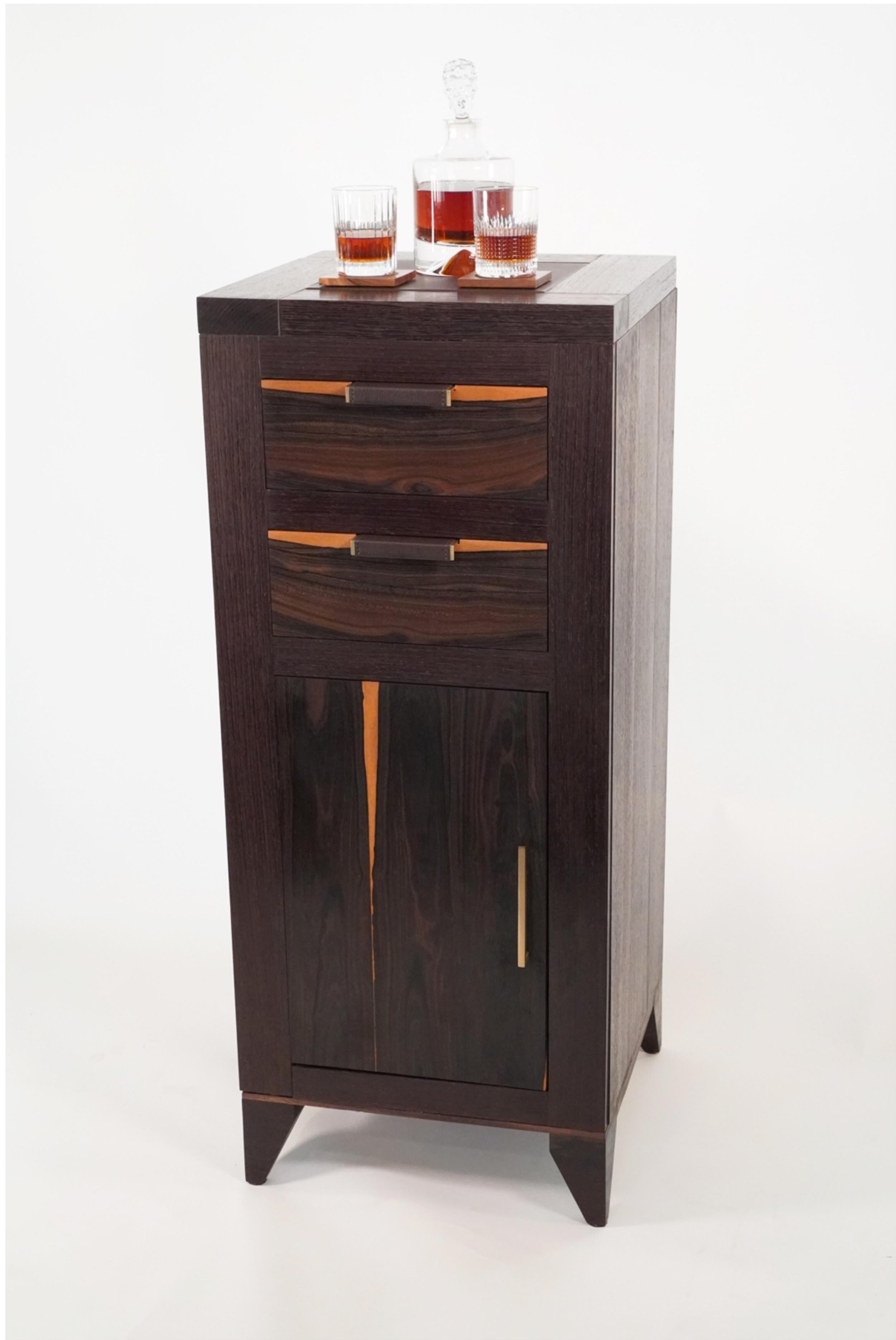 The 21st Century Modern Wenge, Ziricote and Zebrawood liquor cabinet is part of the Walker Design Studios Vanderbilt Collection. The collection is inspired by minimalism and modernism. Exotic hardwoods from across the globe are utilized in this