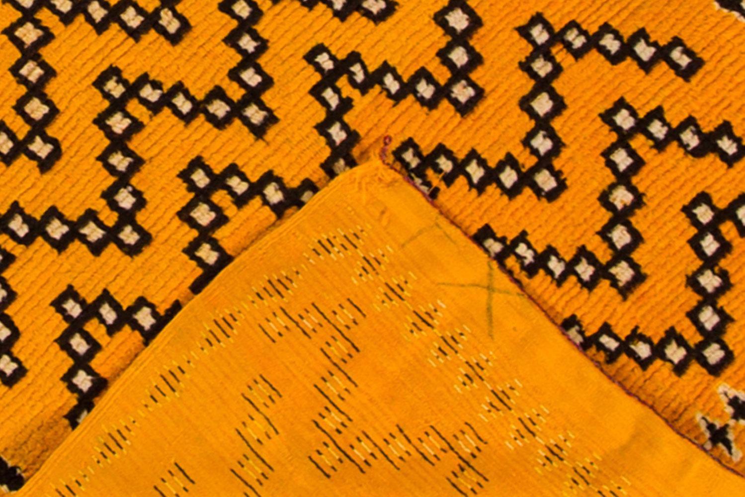 A modern Moroccan rug from the 21st century featuring a burnt orange field and an abstract geometric design in brown and cream. 

The measurements of this rug are 3'7