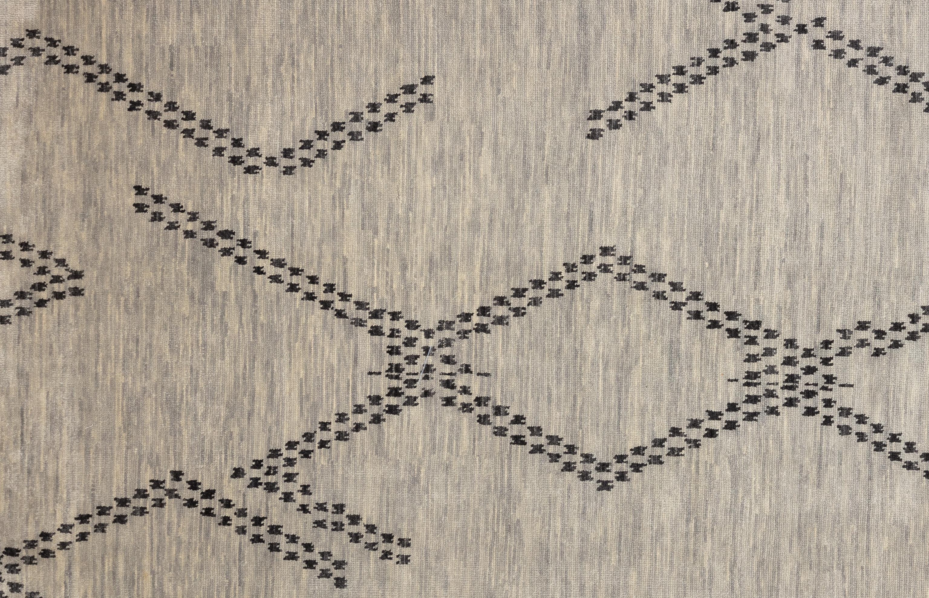 Elevate your home décor with this beautiful Moroccan rug, a true masterpiece of artisan craftsmanship. Featuring intricate geometric patterns and captivating tones on a high plush pile. This rug adds a touch of exotic elegance to any room. Handwoven