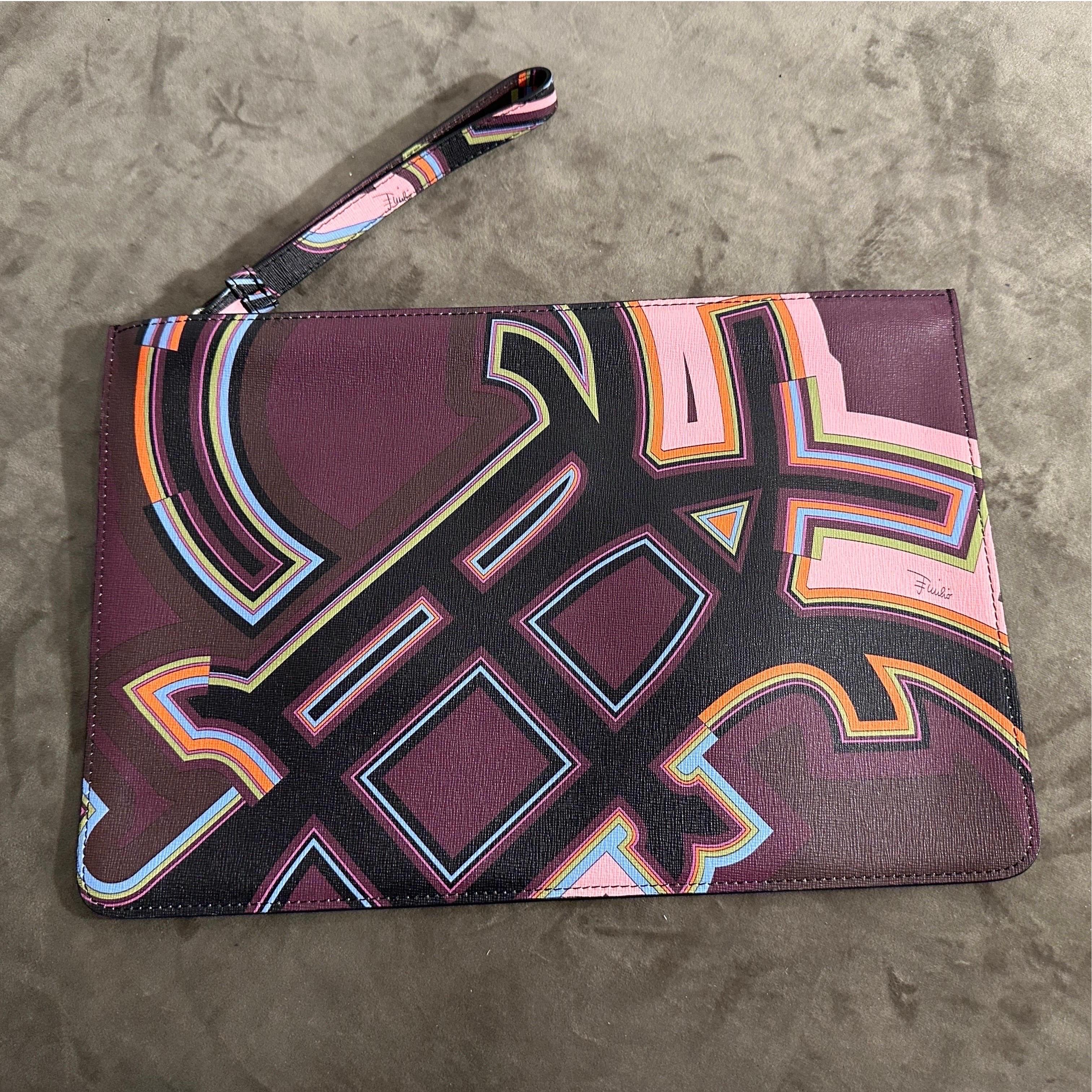 This is an Emilio Pucci pochette, a sleek and stylish accessory showcasing the brand's iconic aesthetic. Emilio Pucci is renowned for its bold, geometric patterns and vibrant color palettes, and this pochette is no exception.
The pouch features a