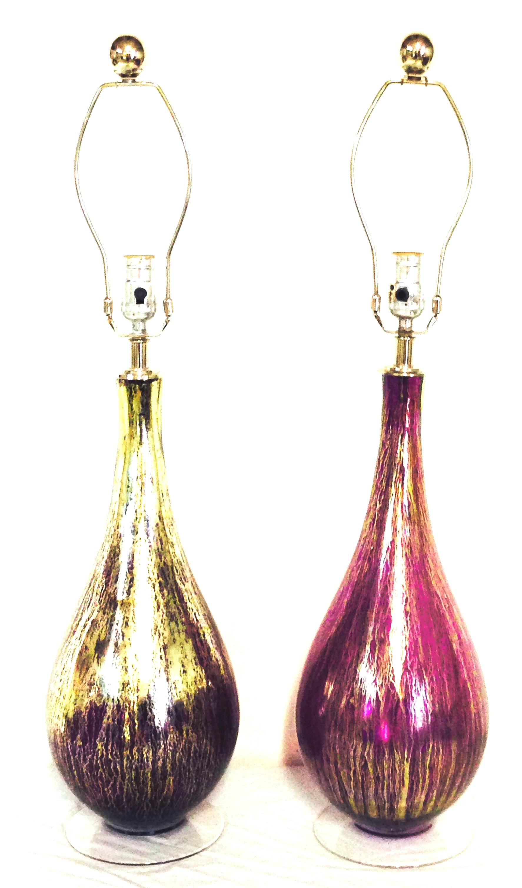 21st Century Murano style pair of blown glass amethyst and 22-karat gold infused table lamps. This pair of new and finely crafted blown glass lamps feature a deep, vivid amethyst tone with gold infused body, clear glass base and silver chromed