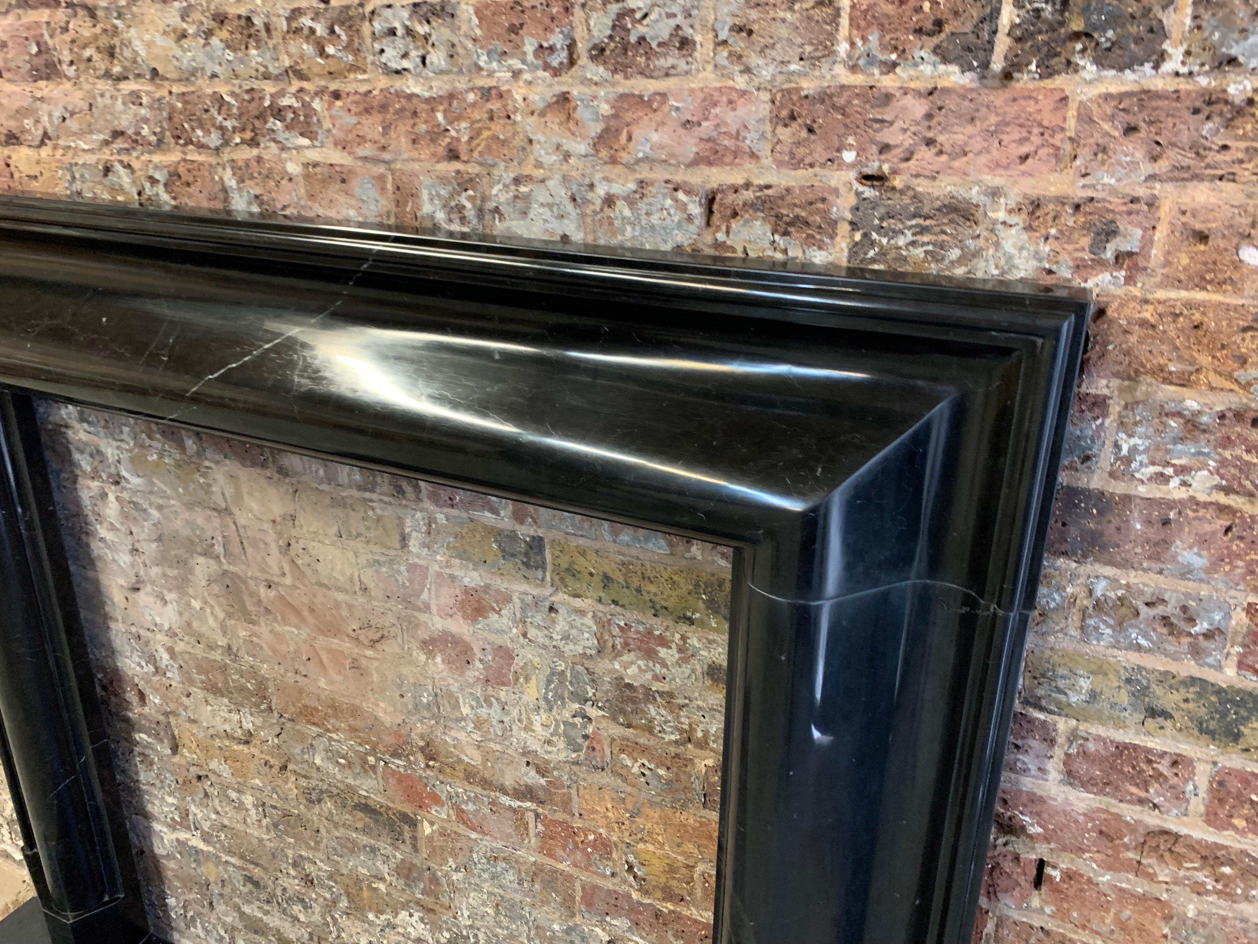 Hand-Carved 21st Century Nero Marquina Marble Fireplace Mantlepiece For Sale