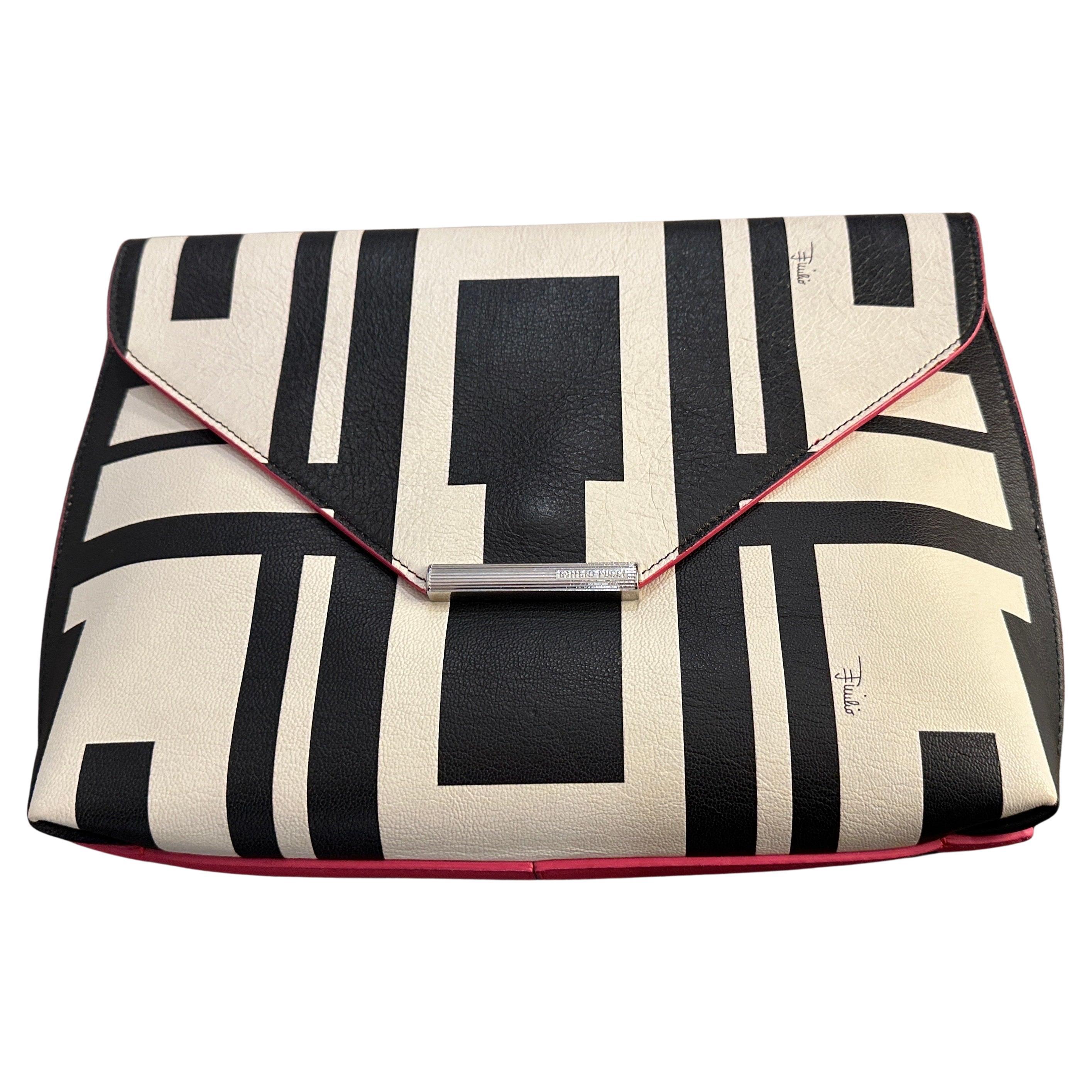 This is a striking black-and-white geometric-patterned bag by Emilio Pucci, exemplifying modern sophistication and artistic design. Crafted in the 21st century and in never-used condition, this bag showcases the brand's signature flair for bold