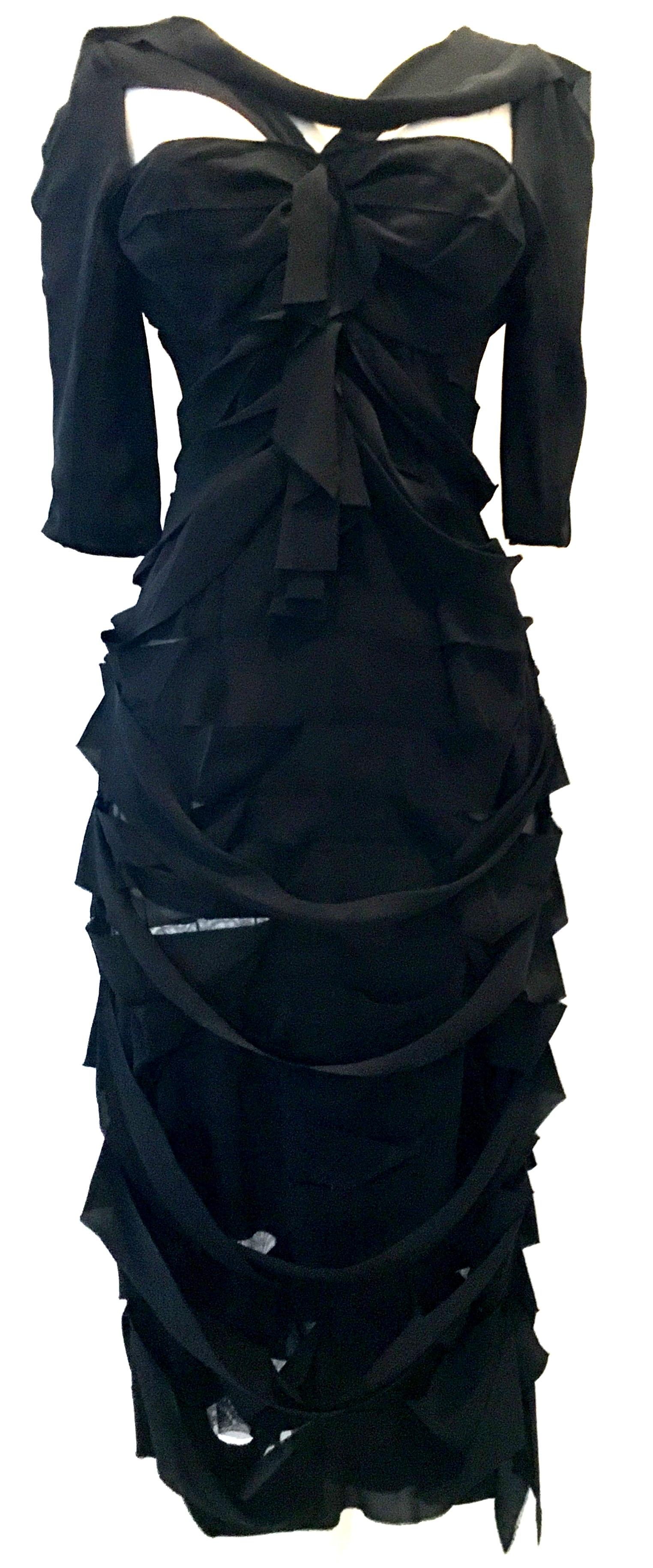 
21st Century & New French Silk Black Dress By, Nina Ricci Paris - Size 6. This finely crafted architectural creation of a 