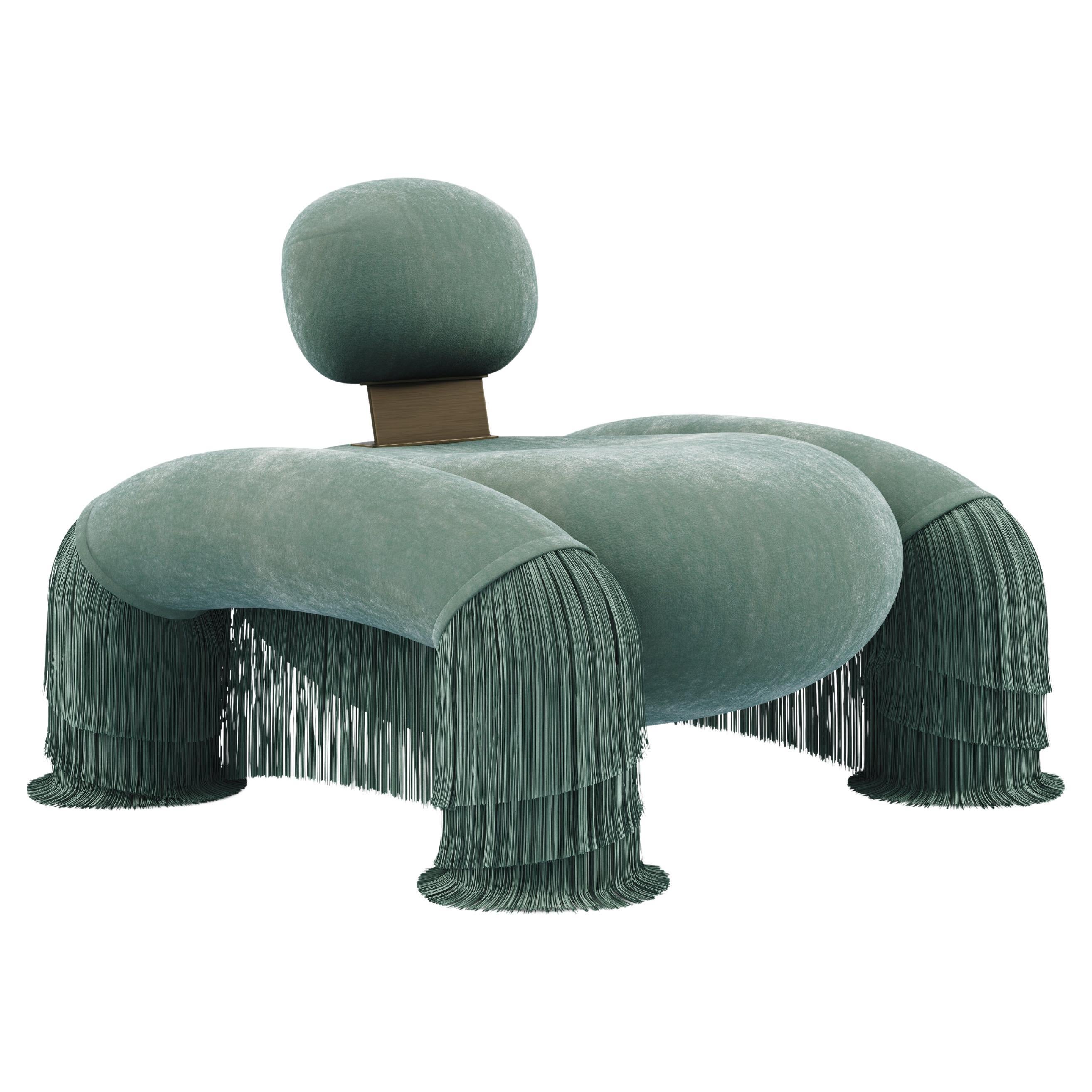 Bold yet poised, the Odessa Armchair exudes strength wrapped in softness. Upholstered in sumptuous velvet and adorned with delicate fringes, it balances power with elegance in every line. The chair’s silhouette is confident and curvaceous, drawing