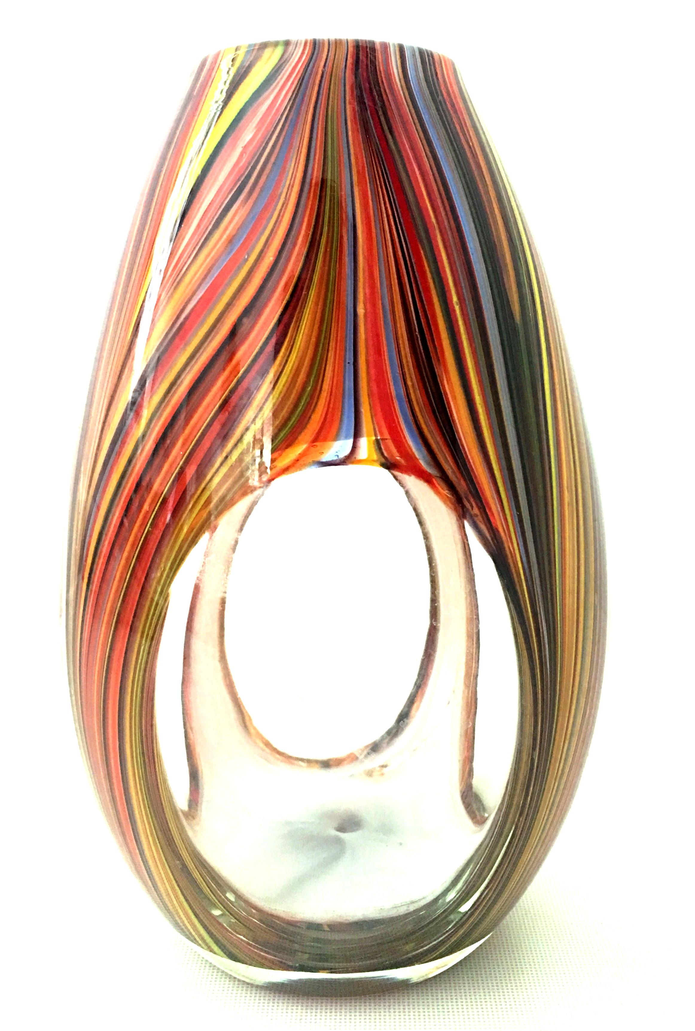 21st century and new Missoni modern optical striped blown glass vase. This new and never used ultra modern optical striped design blown glass vase by Missoni features a color palette with shades of orange, yellow, periwinkle, red and brown. This