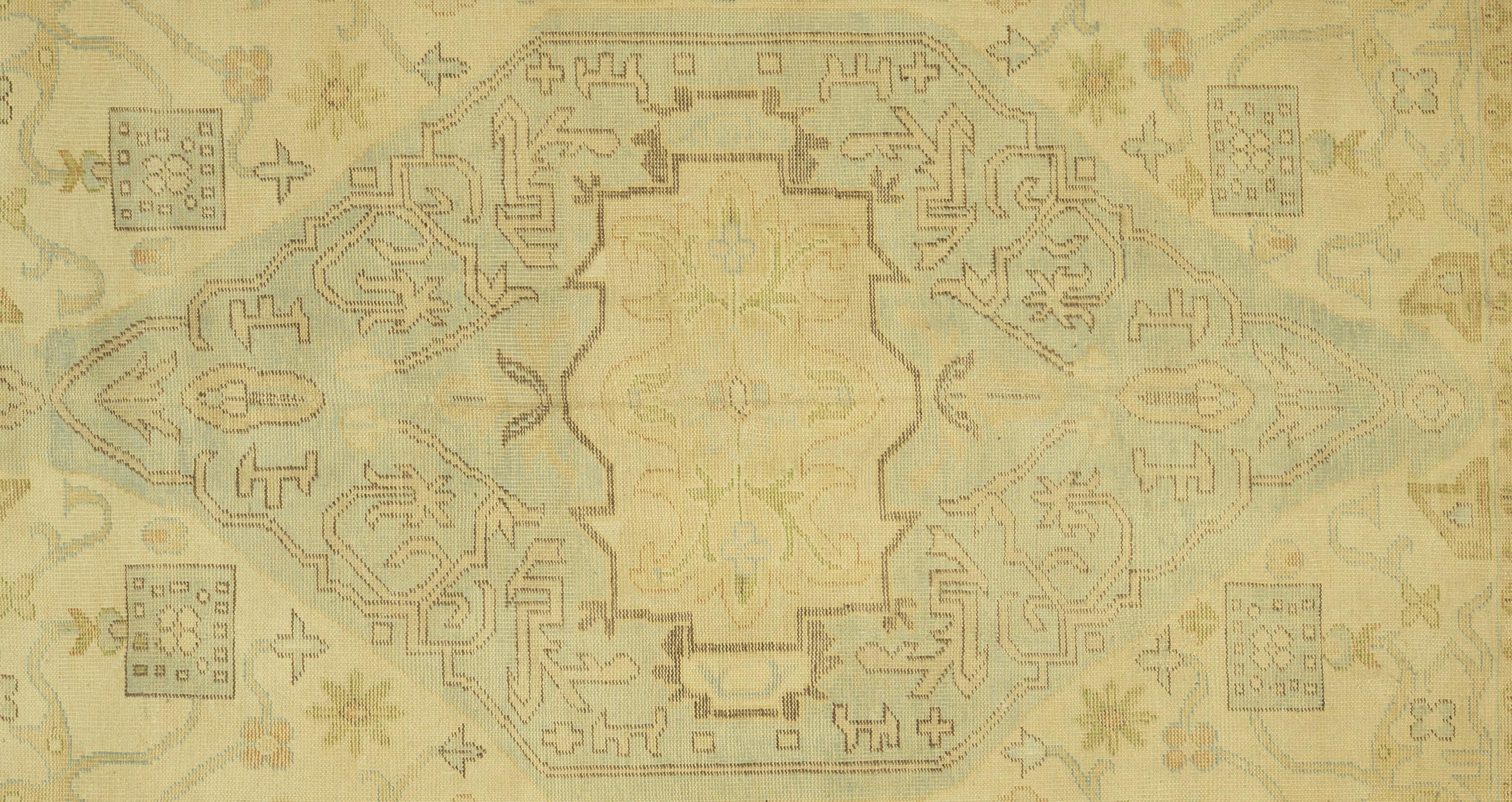 This Oushak rug from Turkey is hand-knotted from pure wool, offering both durability and a soft, inviting texture underfoot. Its design draws inspiration from classic motifs, reimagined in a soothing palette of neutral tones that bring a sense of
