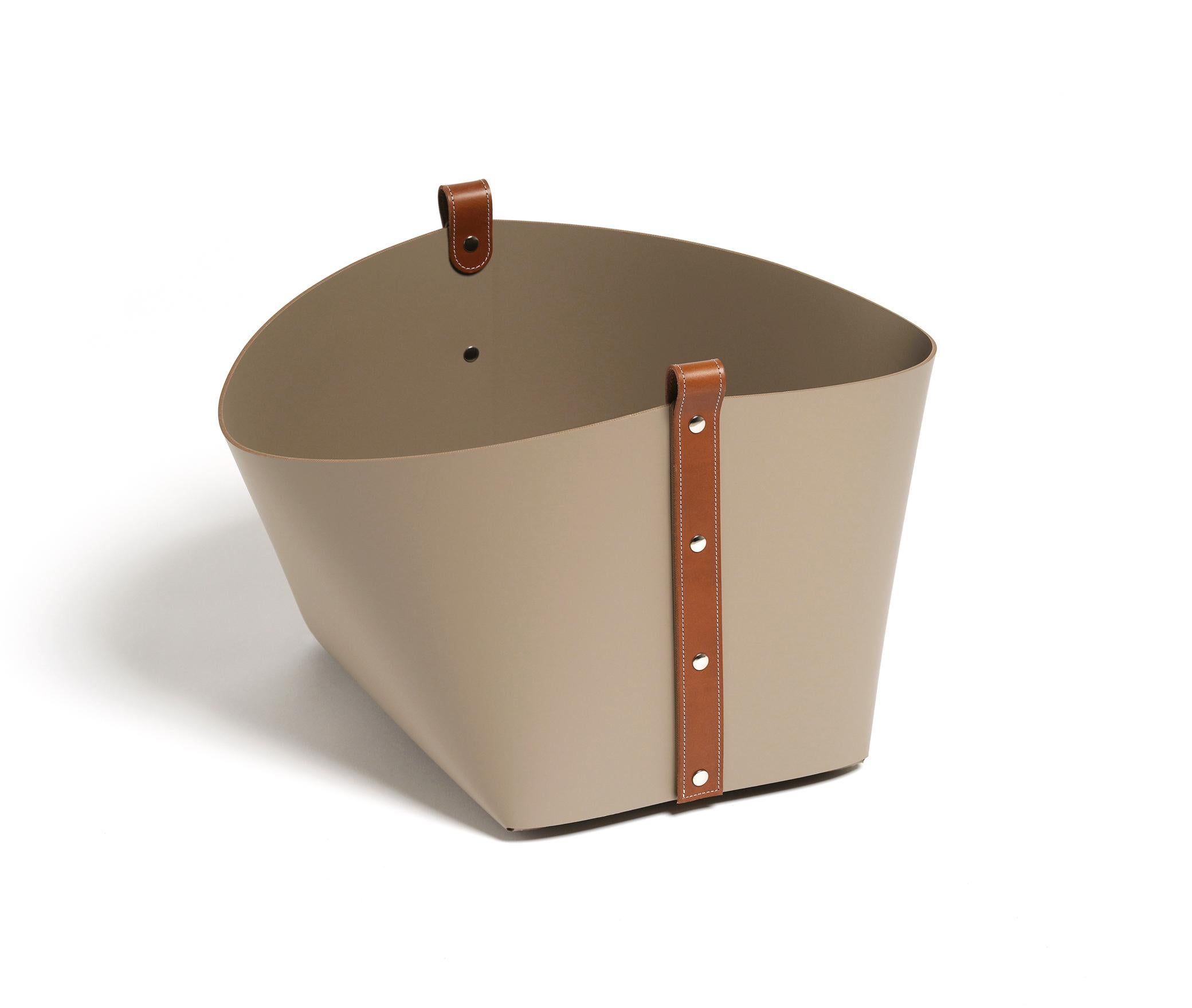 Ovo basket: Compact yet capacious.

Fashioned of resistant recycled leather, with tan or black this basket boasts an unstructured silhouette with flared sides supported by a sturdy rectangular base that can hold a large number of items. It might