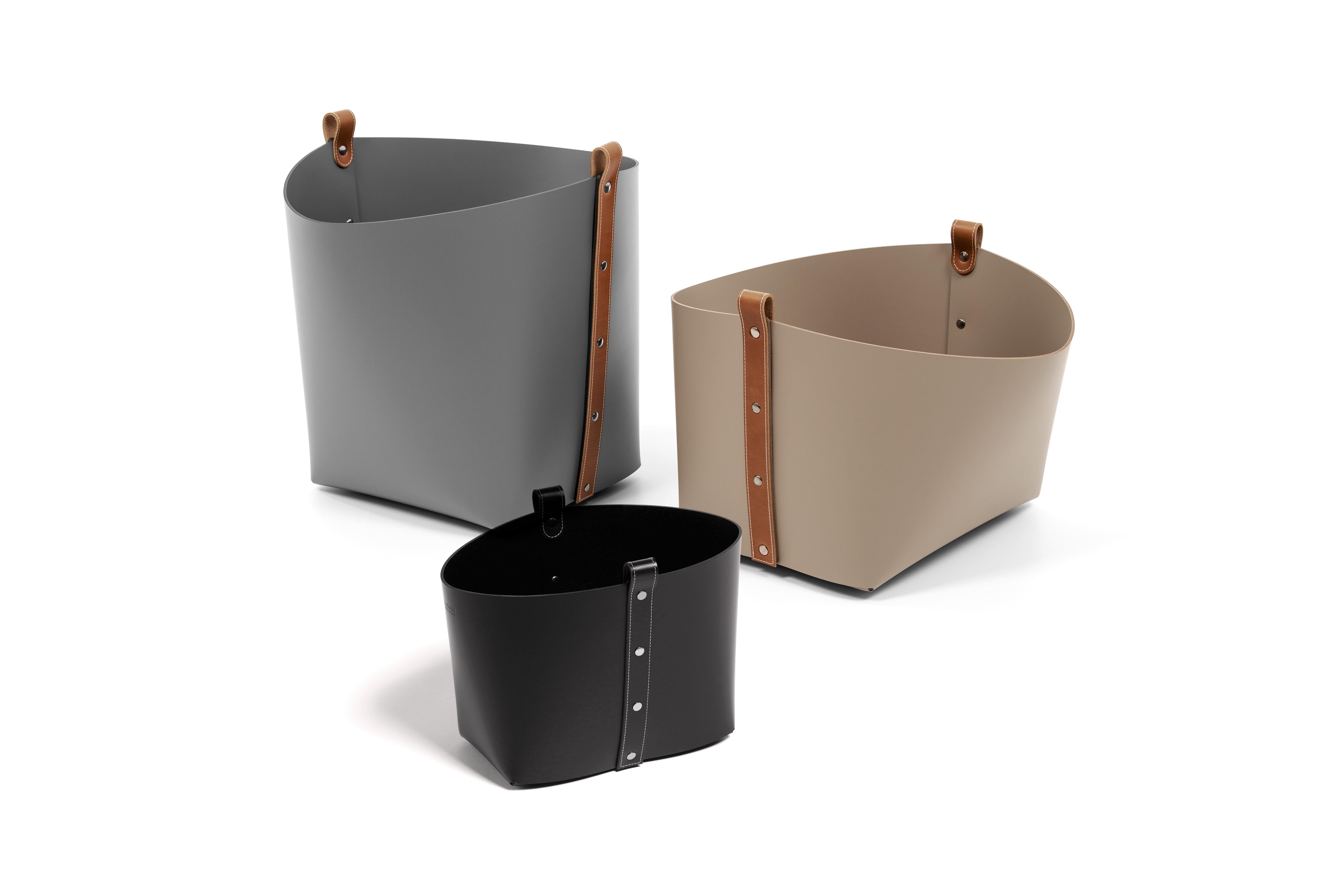 Ovo basket: Compact yet capacious.

Fashioned of resistant recycled leather, with tan or black this basket boasts an unstructured silhouette with flared sides supported by a sturdy rectangular base that can hold a large number of items. It might