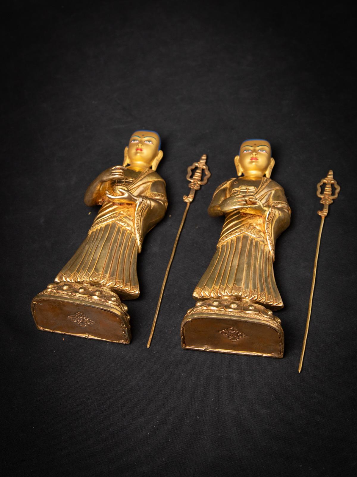 Discover this pair of bronze Nepali monk statues, expertly crafted in very high quality to honor traditional artistry. Made from solid bronze and fire gilded with 24 karat gold, these statues feature beautifully gold-painted faces for added detail