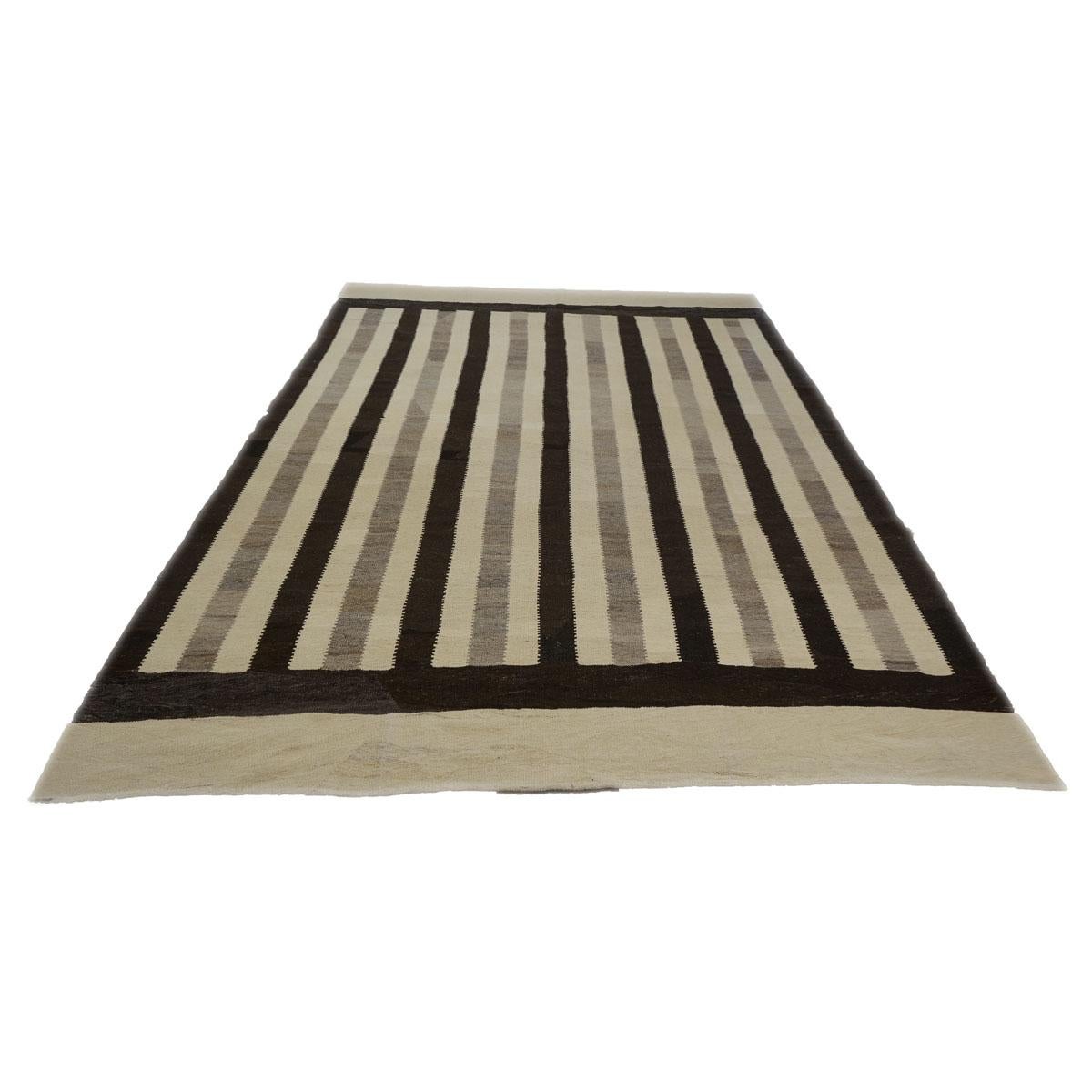 This 21st century Persian flat-weave modern wool handwoven 8x11 ivory black Kilim made with 100% hand twisted wool fibers undid brown and black sheep to create the stripes. Soft to touch and reversible 
Actual size: 8.4 x 11.3 
Pile: Wool