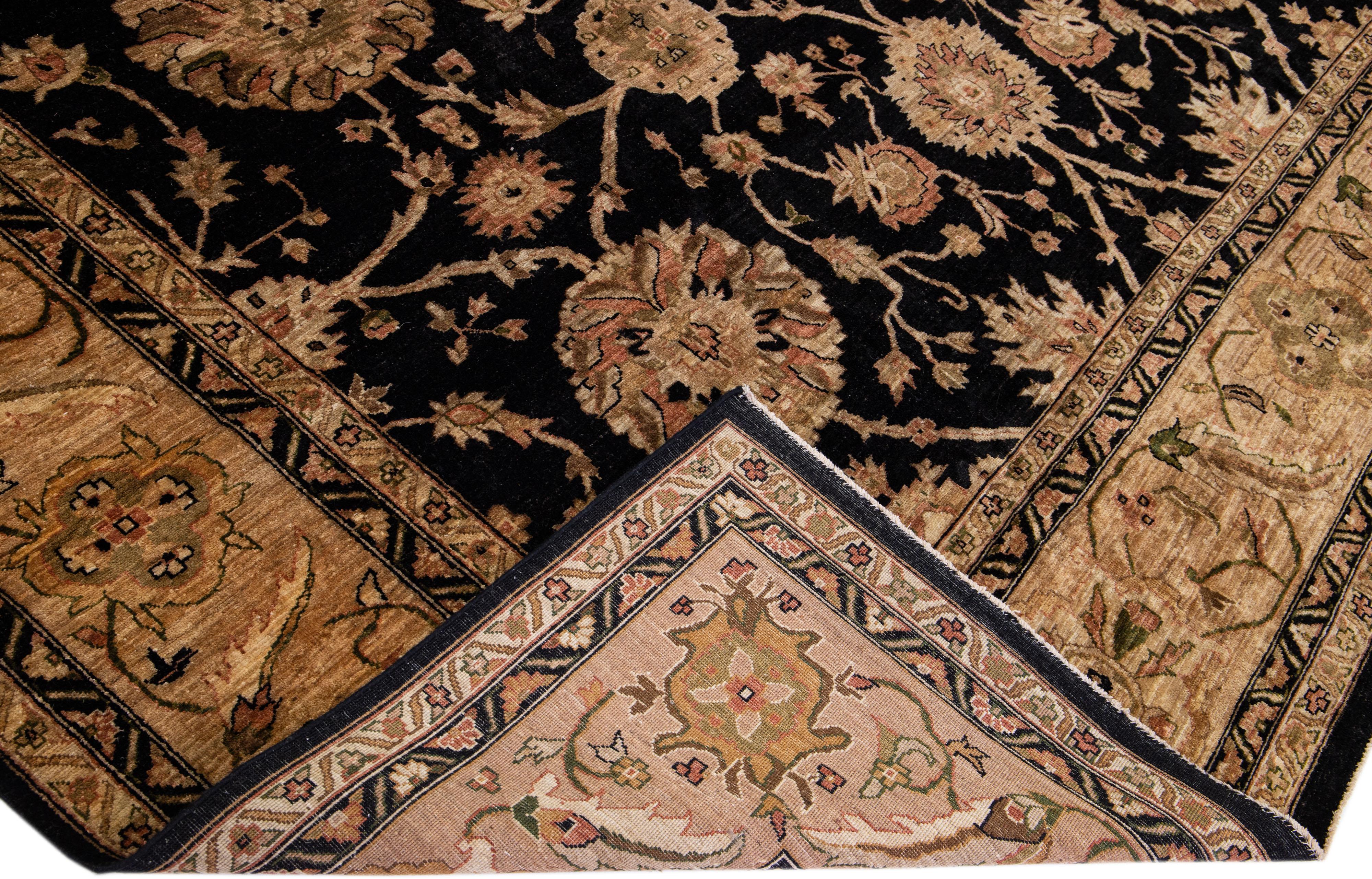 Beautiful Paki Peshawar hand-knotted wool rug with a black color field. This modern rug has a brown frame with green, golden, and red accents in an all-over Classic vine scroll and a palmettes motif.

This rug measures: 11'7