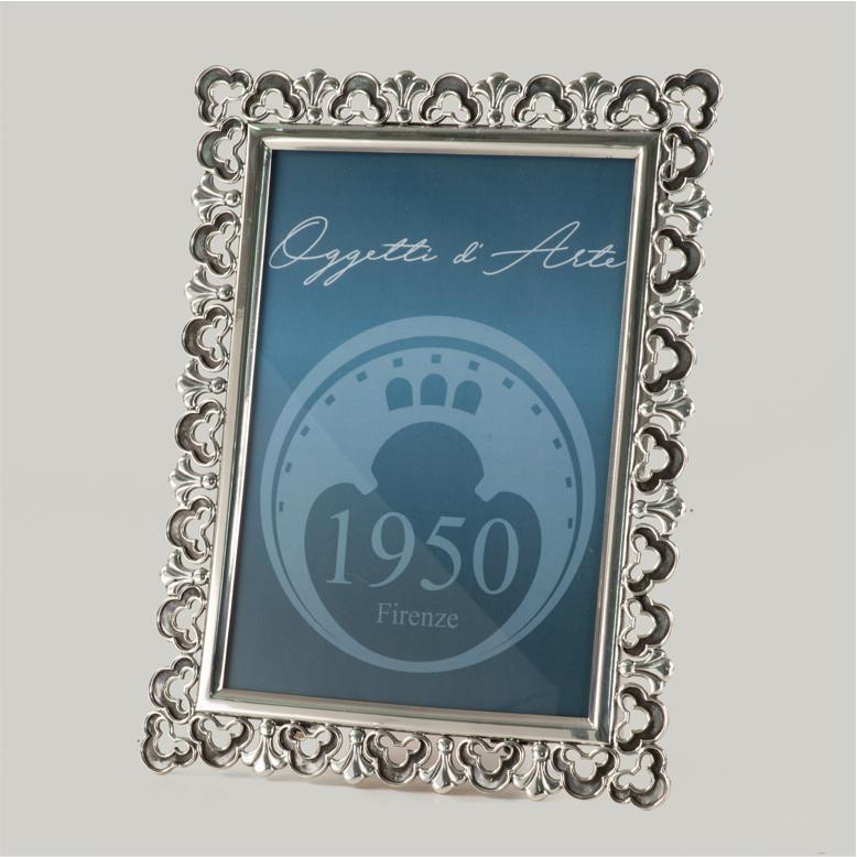 Elegant picture frame made of lost wax casting bronze, silvered,  ideal for enhancing your most precious memories. Italian artisan product. The richly decorated border features a delicate three-leaf clover motif, created using the lost wax casting