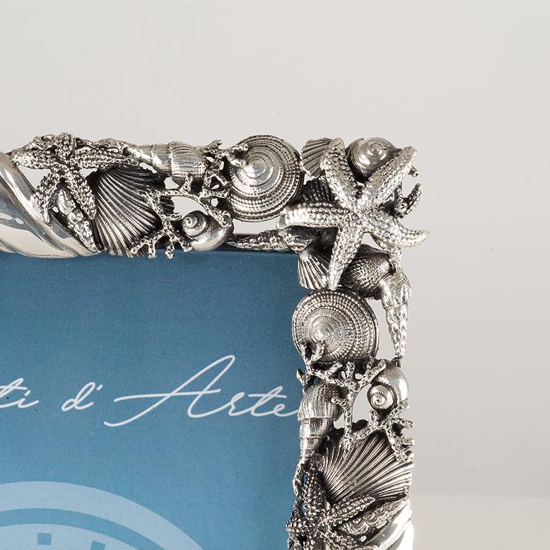 Elegant picture frame made of lost wax casting bronze, silvered,  ideal for enhancing your most precious memories. Italian artisan product. The richly decorated border features a delicate marine motif, created using the lost wax casting technique.