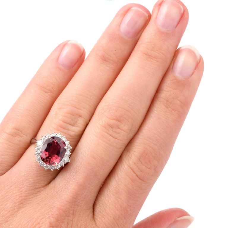 This Diamond and Pink Tourmaline ring comes with the versatility of being worn as an engagement ring of color or a stately cocktail ring and was crafted in Platinum. Adorning the center is an oval shaped deep and rich colored Pink Tourmaline