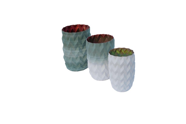 This set of three hand painted vases in porcelain is unique of its kind. 

As the result of a fine 3D processing, the extra fine shell of each vase has a thickness of 1 millimetre, making them as light as paper but resistant as porcelain.

The