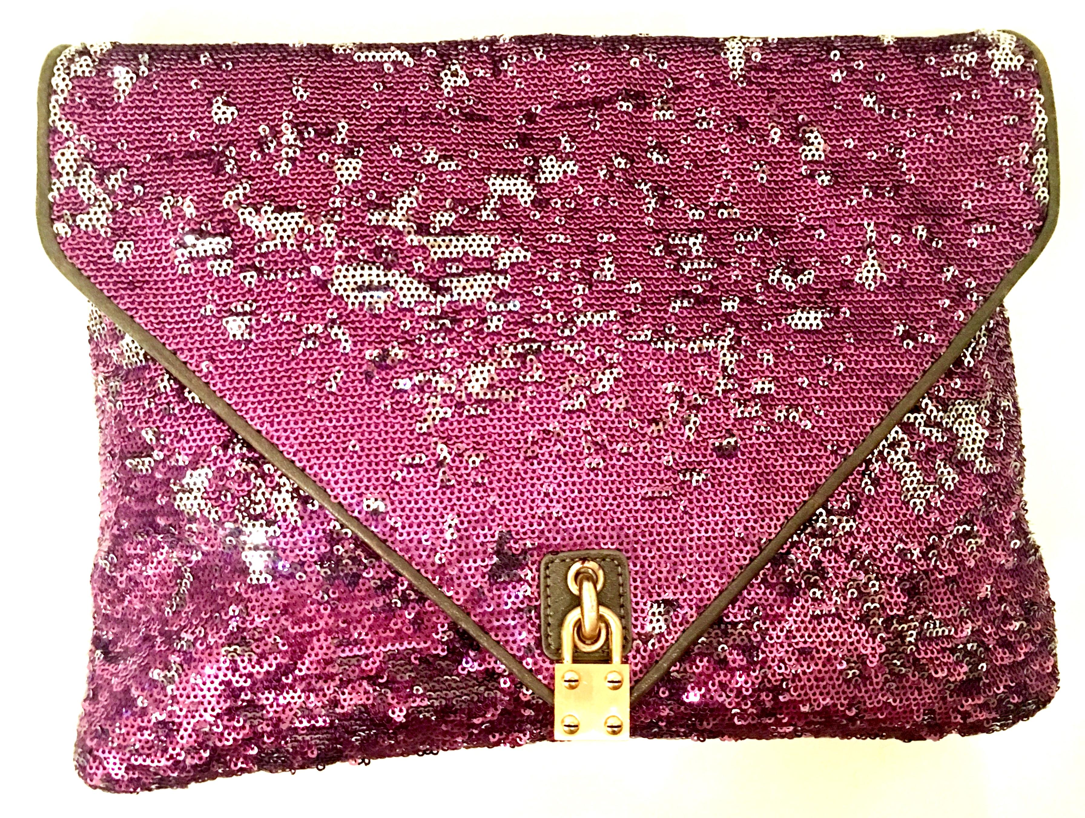 21st Century Reverse Sequin & Leather Envelope Clutch Handbag By, Alexis Hudson. This new with out tags envelope clutch hand bag features brown leather trim with gilt brass hardware. The purple sequins can have more silver tones or less with the